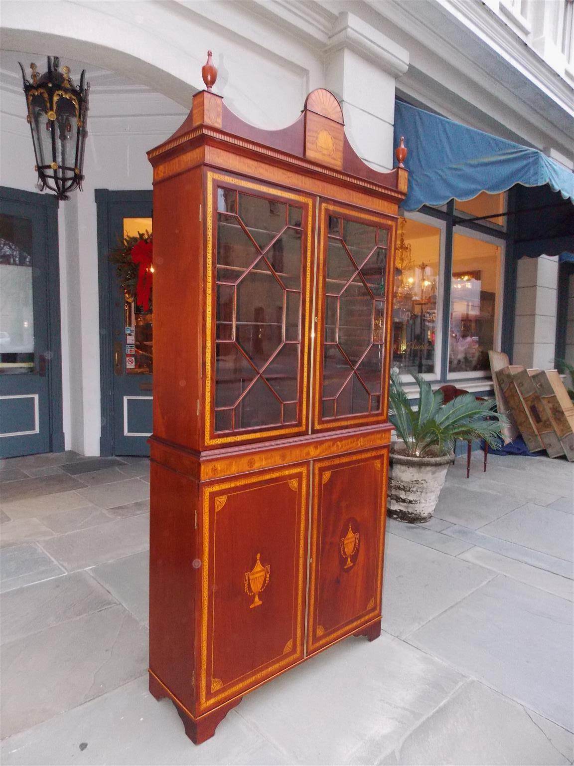 English Regency mahogany book case with an arched cornice, corner urn finials resting on oval floral satinwood inlaid plinths, centered satinwood inlaid patera fan over satinwood inlaid shell, satinwood fluted and pinwheel inlays, hinged upper case