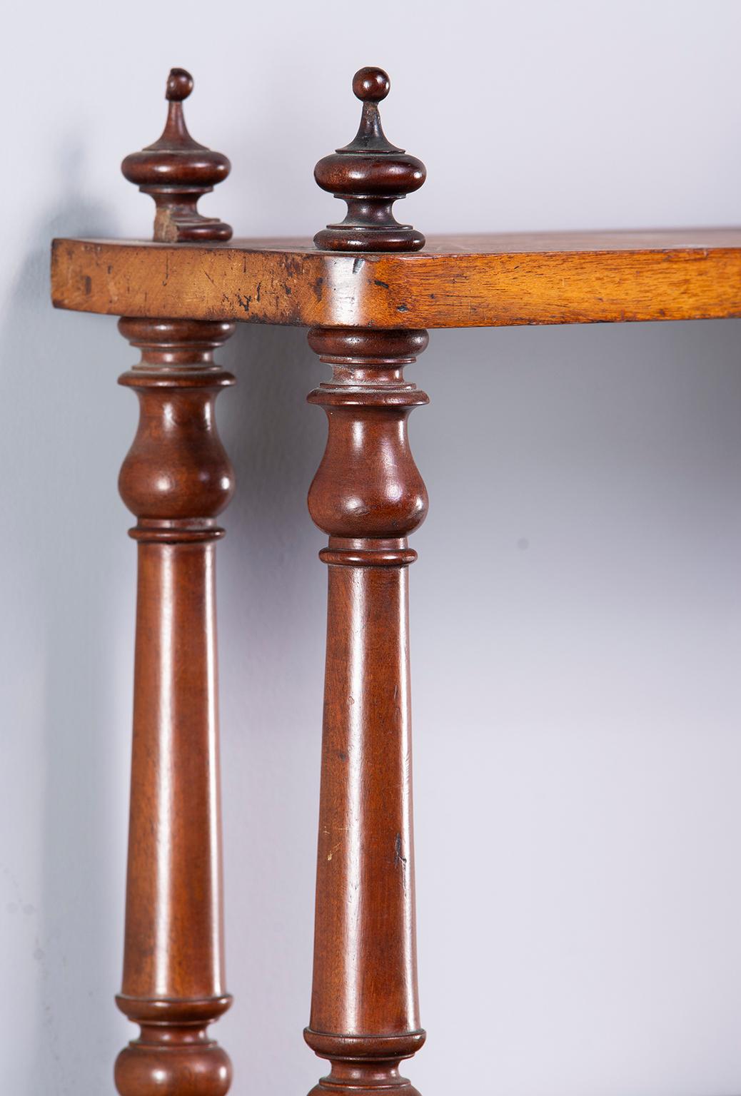 English Regency period mahogany wall shelf is four feet wide with three shelves and fancy turned supports, circa 1830s.
 