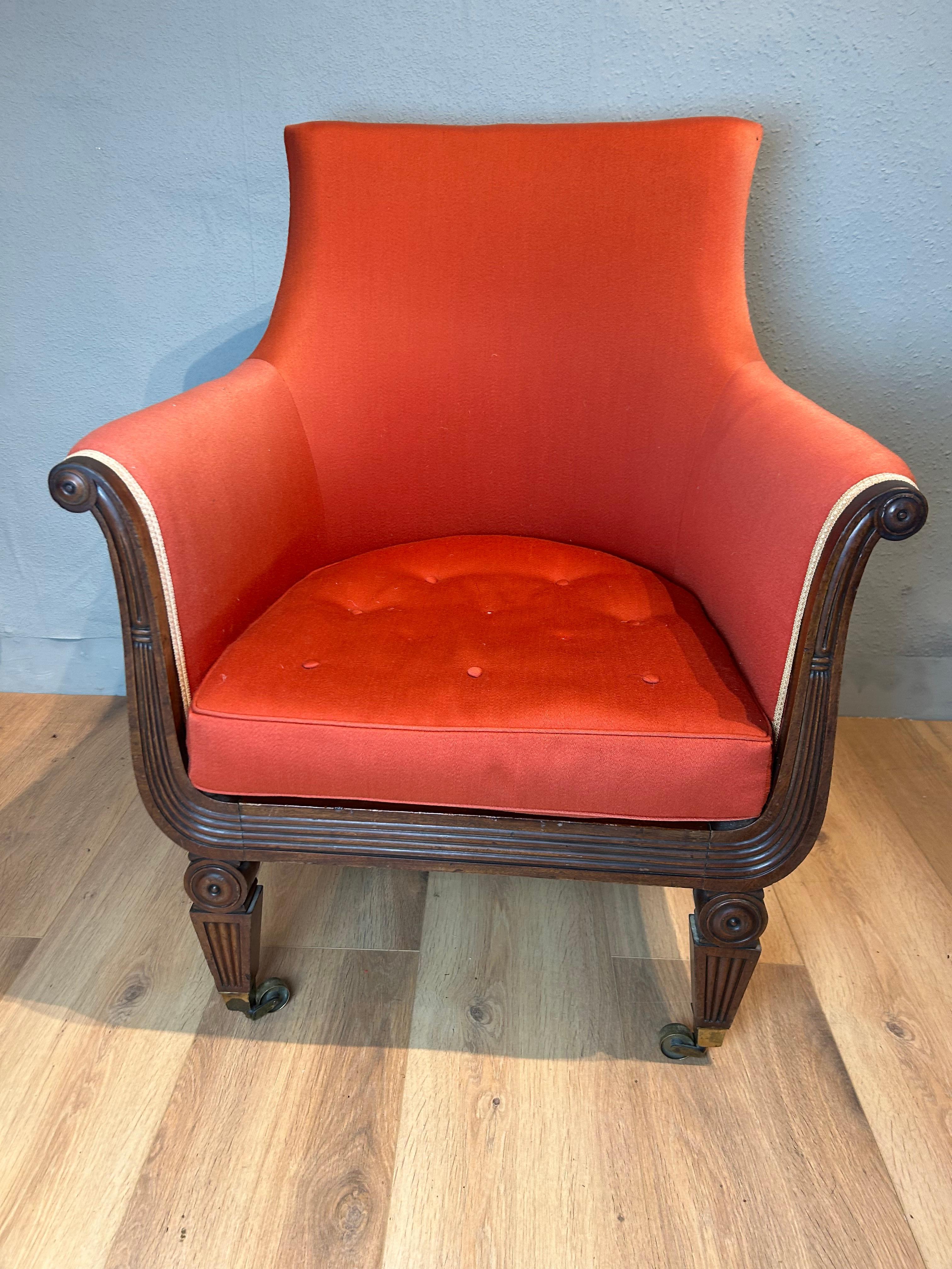 English library mahogany arm chair in the manner of Marsh and Tatham with shaped spoon back, reeded scrolled lyre front resting on turned roundels with tapered reeded flat faced legs ending on square brass cup castors.