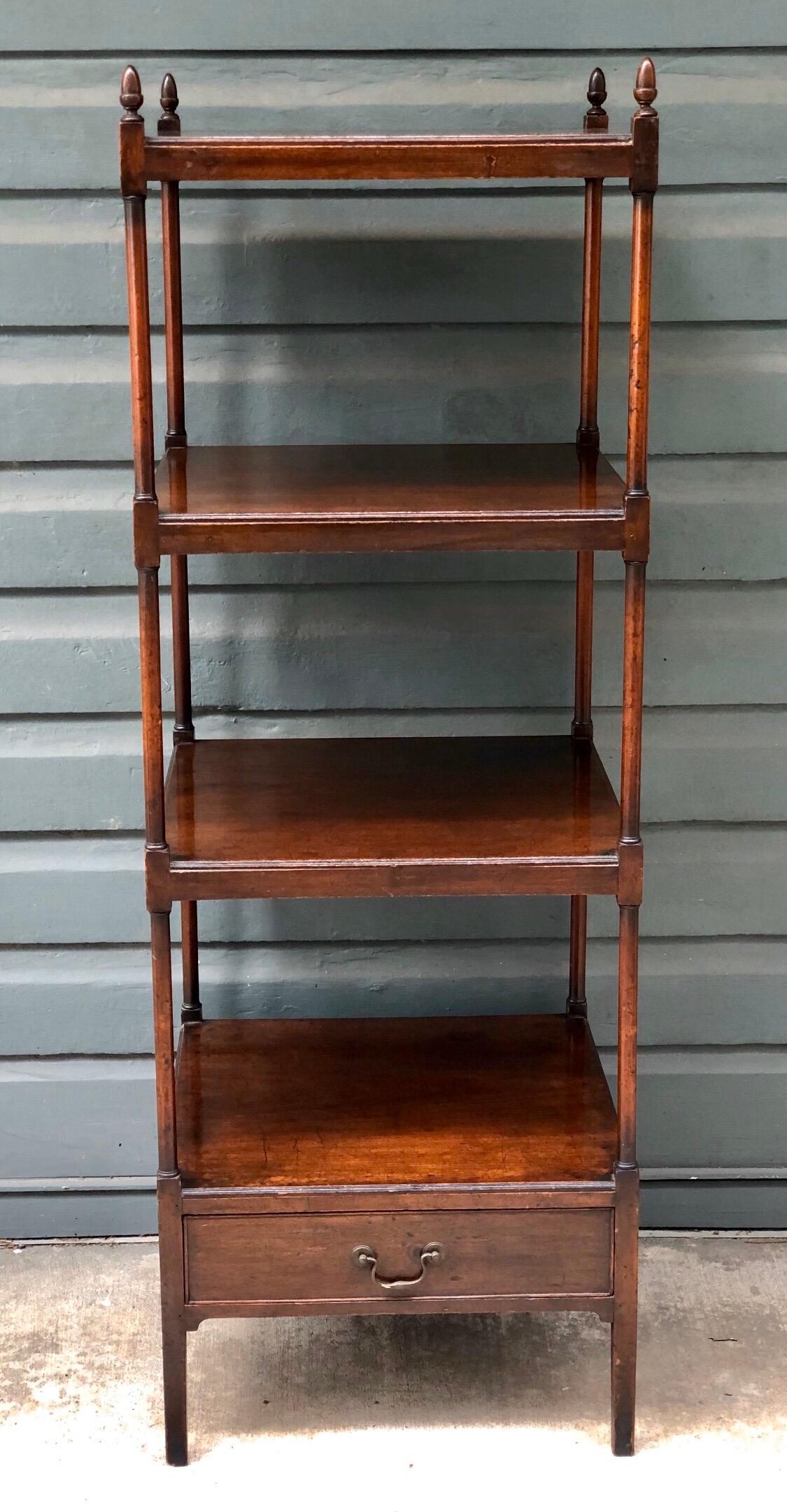 English four-tier library stand with one-drawer. This Regency étagère is solid mahogany and has turned column supports between the shelves and a Classic Marlborough leg below the drawer.