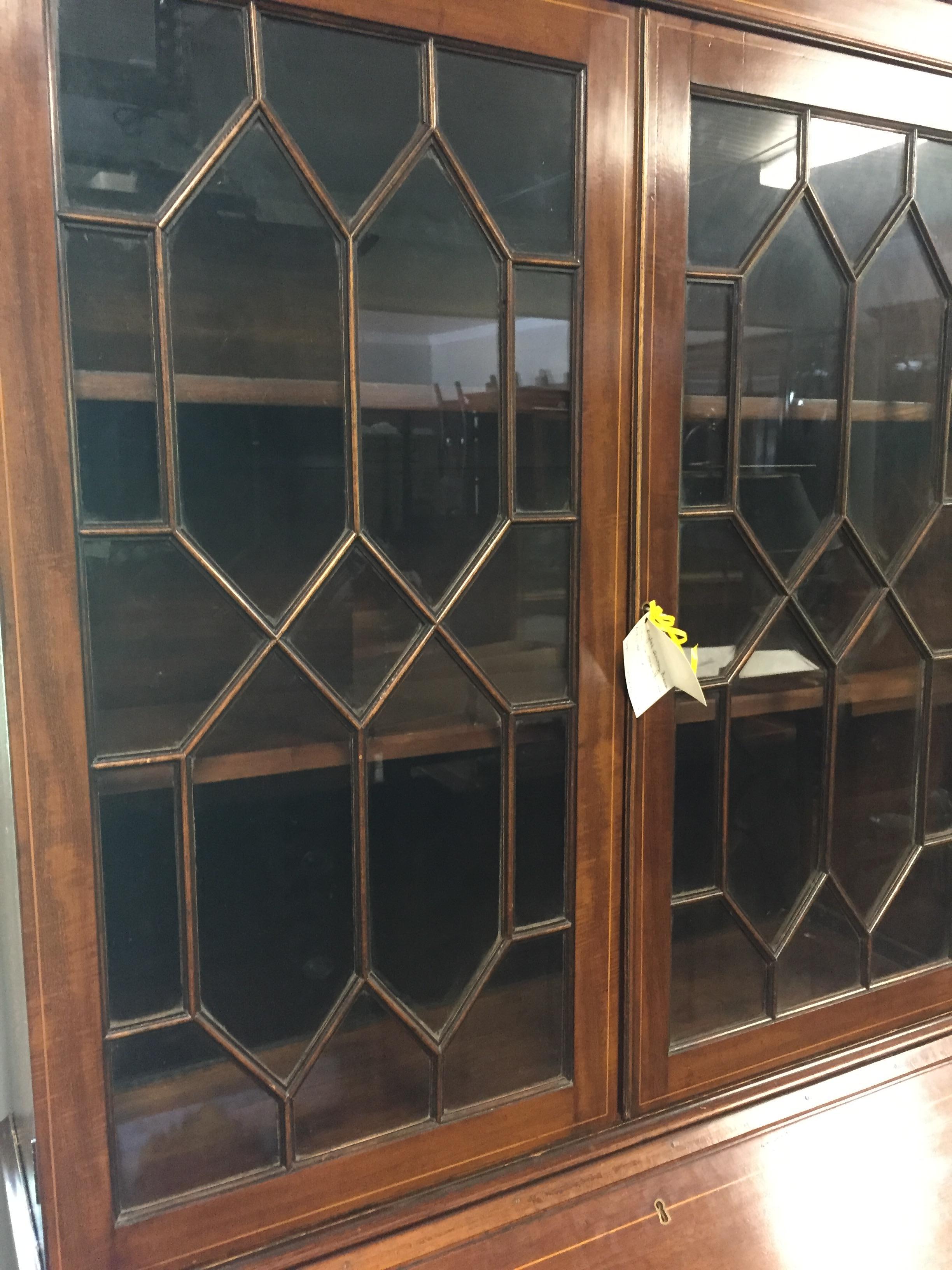 Mahogany secretary bookcase with satin wood line inlay on each drawer, interior pigeon hole drawers, doors and crown. Medium mahogany with excellent finish, recently professionally restored. Oak interiors, two part construction for easy moving,