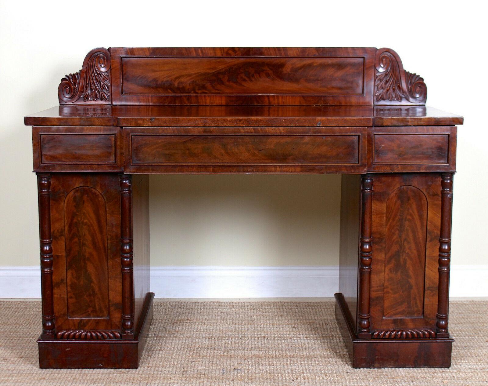 Regency period breakfront twin pedestal sideboard.
The Cuban mahogany marquetry work boasting a well figured polished flamed grain.
A well carved backsplash above the breakfront form top fitted three drawers to frieze with oak lined