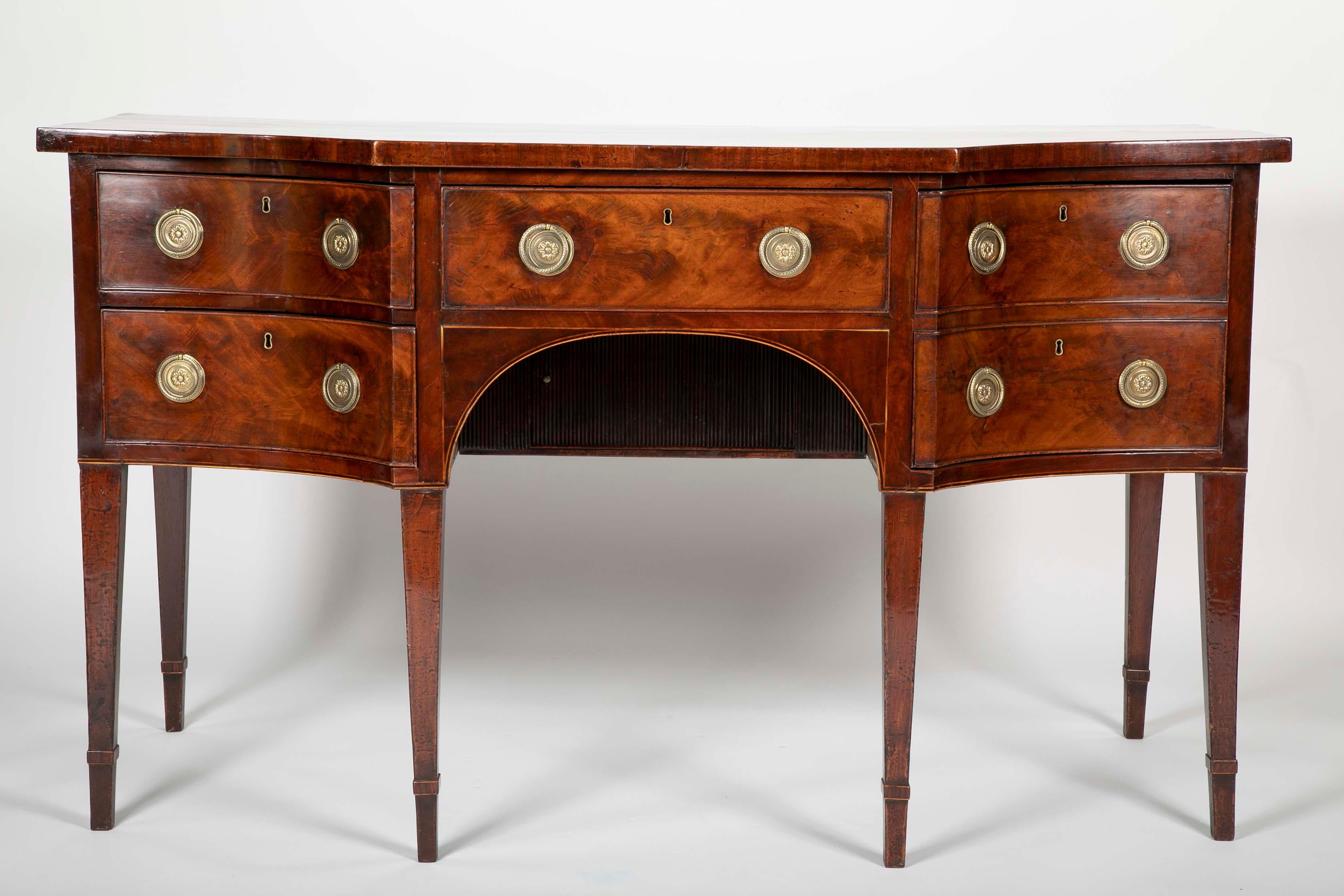A mahogany sideboard with flat front and concave sides. English Regency. Provenance- loaned to WM Underwoood by G.C. Seybolt, early 19th century.