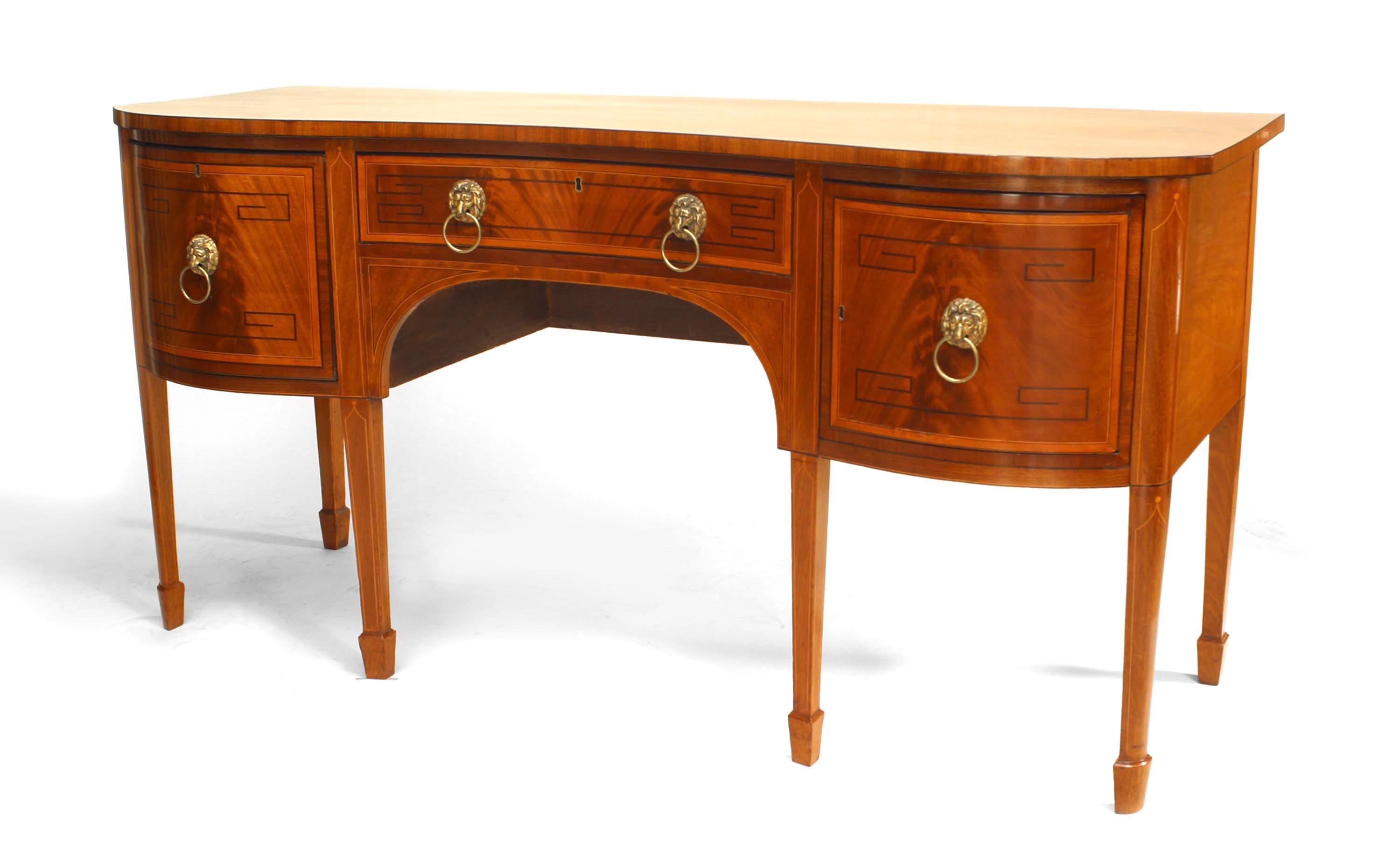 English Regency mahogany sideboard with double bow front design and banded inlay and ebonized Greek key design with brass lion head drawer handles with spade form feet.
