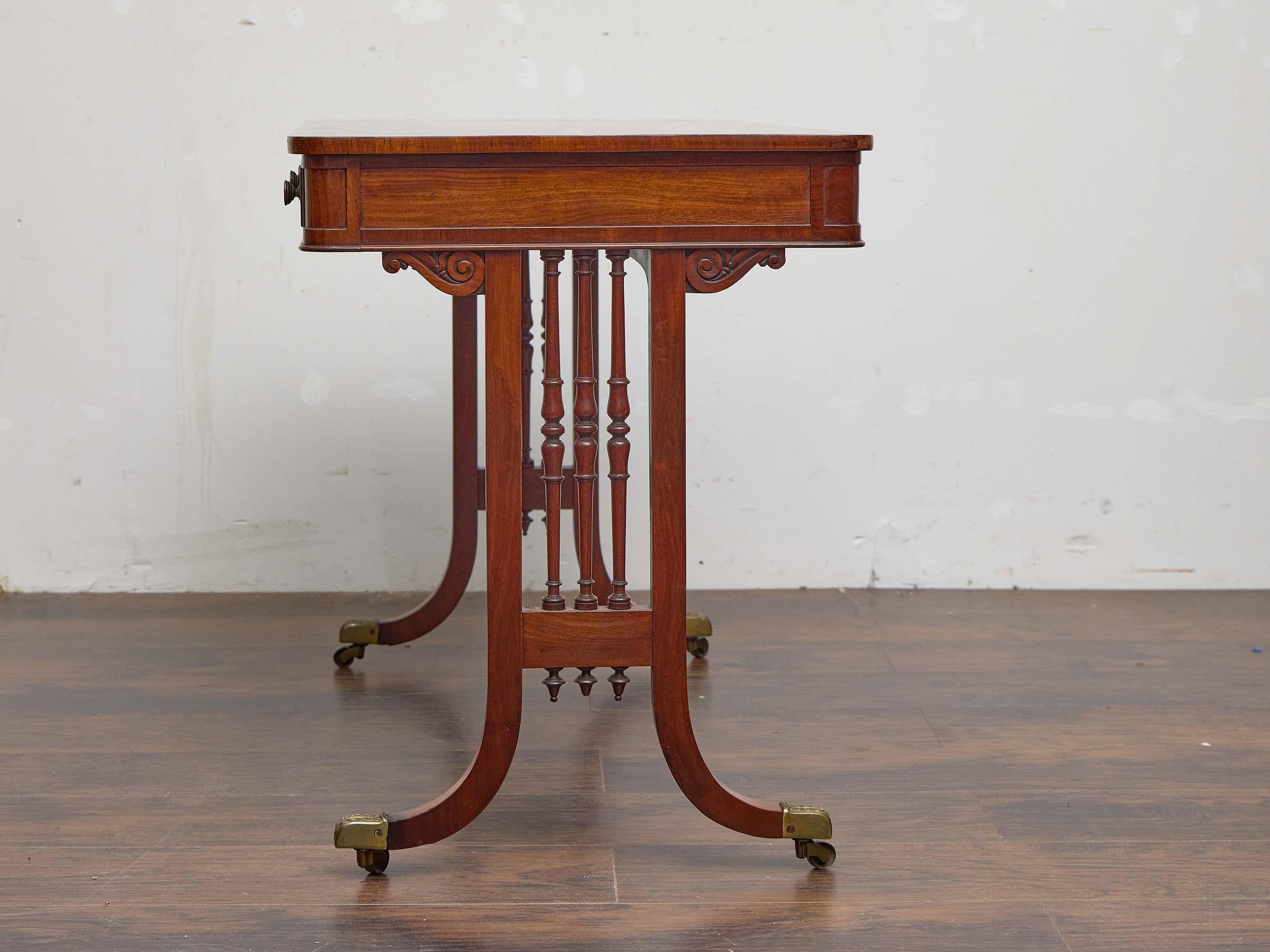 19th Century English Regency Mahogany Writing Desk with Pierced Sides and Casters For Sale