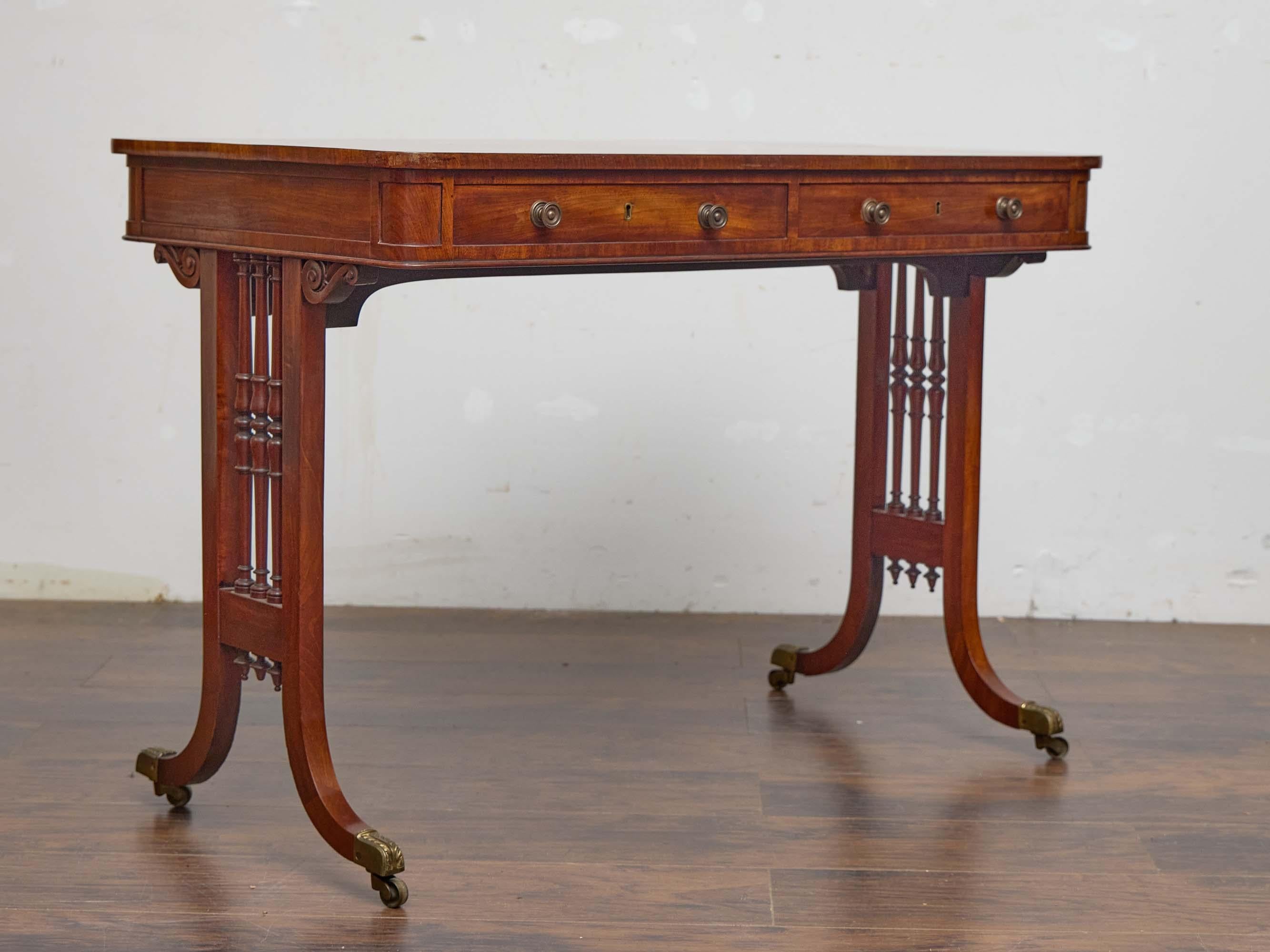 Wood English Regency Mahogany Writing Desk with Pierced Sides and Casters For Sale