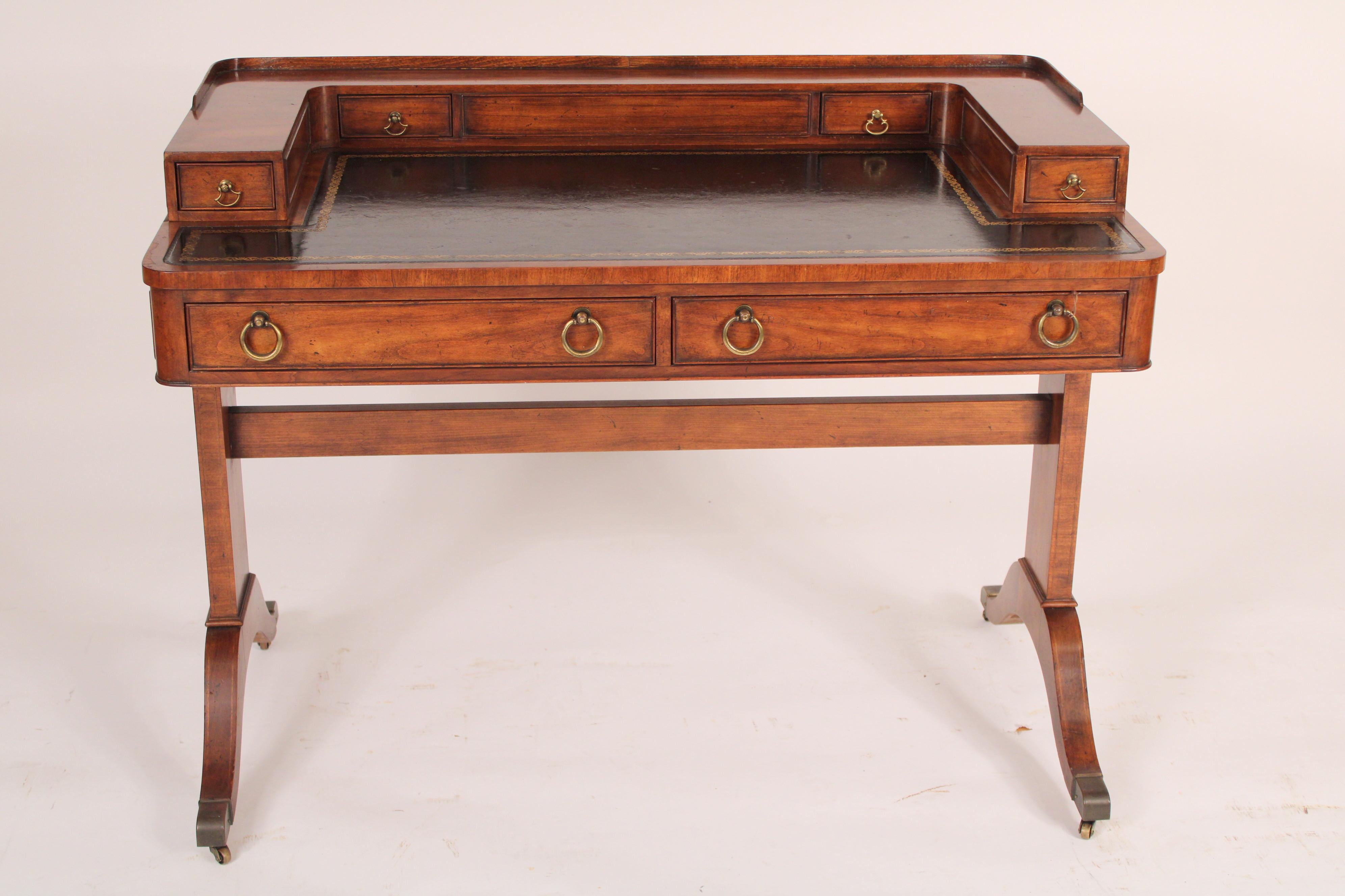 English regency style mahogany writing table with a tooled leather top. With a super structure with two long drawers on either side and two short inner drawers, a tooled leather top, two frieze drawers with nicely nicely figured mahogany, two