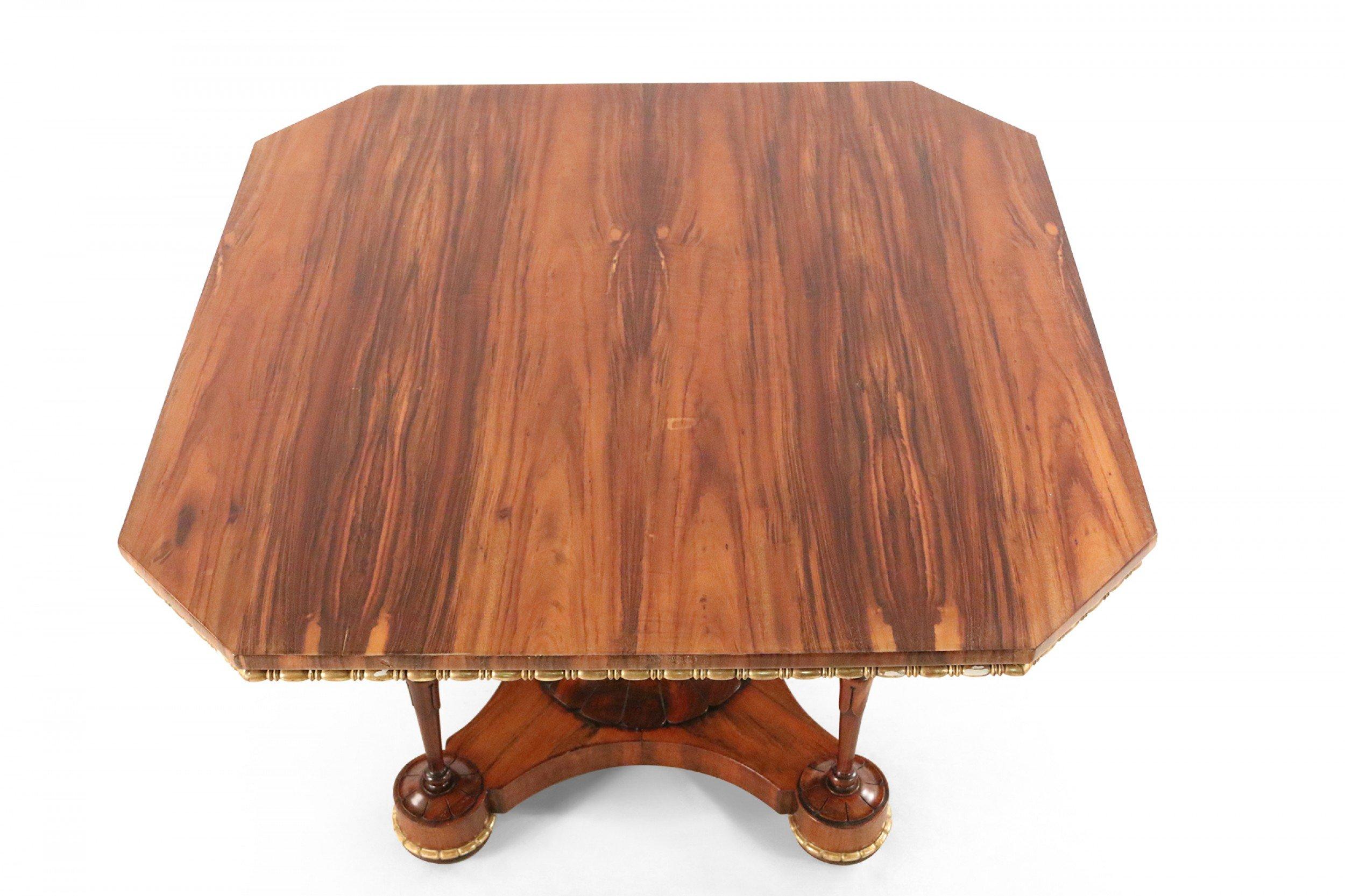 English Regency (circa 1850s) walnut and gilt trimmed center table with a square top and canted corners supported on a centered pedestal and 4 corner columns on a platform base (attributed to MOREL & SEDDON) (Domestic Shipping Only).
