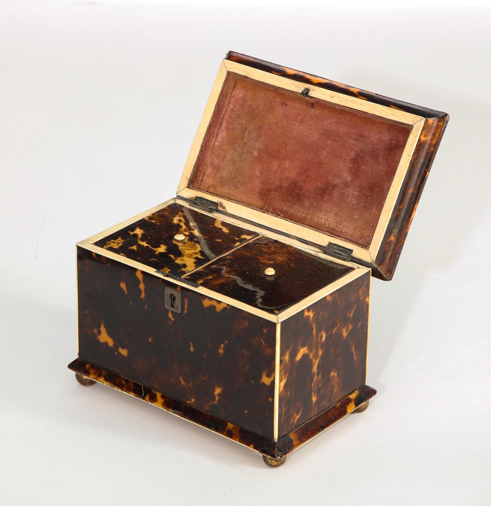 Unusual pagoda form caddy finely figured veneers. Interior lids are original and match the exterior of the caddy, resting on brass ball feet
