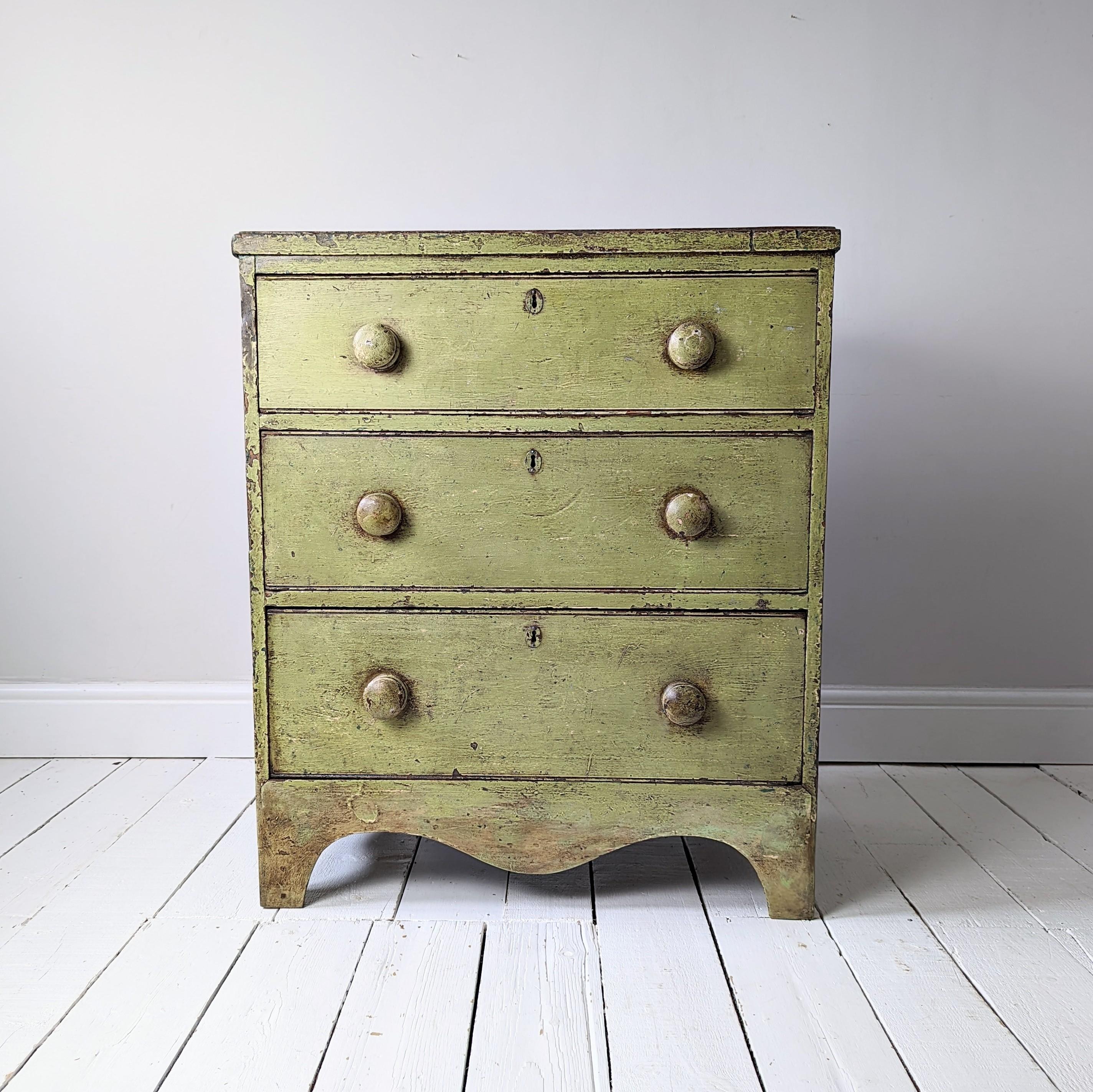 English pine chest of drawers in pale green paint.

Three drawers that run well and standing on bracket feet with a shaped apron on all sides. 

A highly original piece of country furniture with a dry and unfettered surface. 








