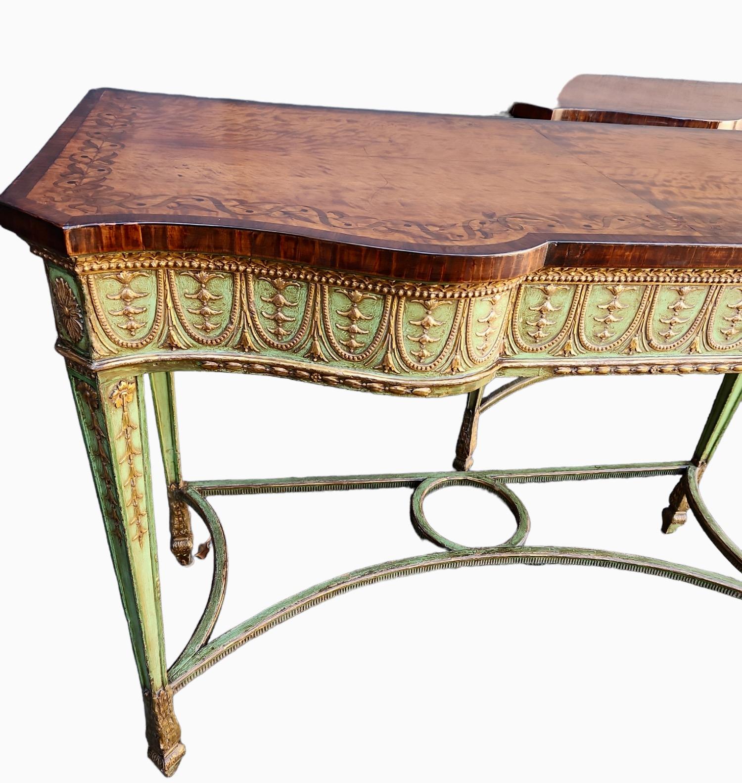 Fine pair of English consoles. Painted background with finely-carved gilt wood details. Tops of consoles are satinwood with finely inlaid motif.