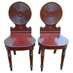 English Regency Pair of Carved Mahogany Hall Chairs with Carved Circular Backs