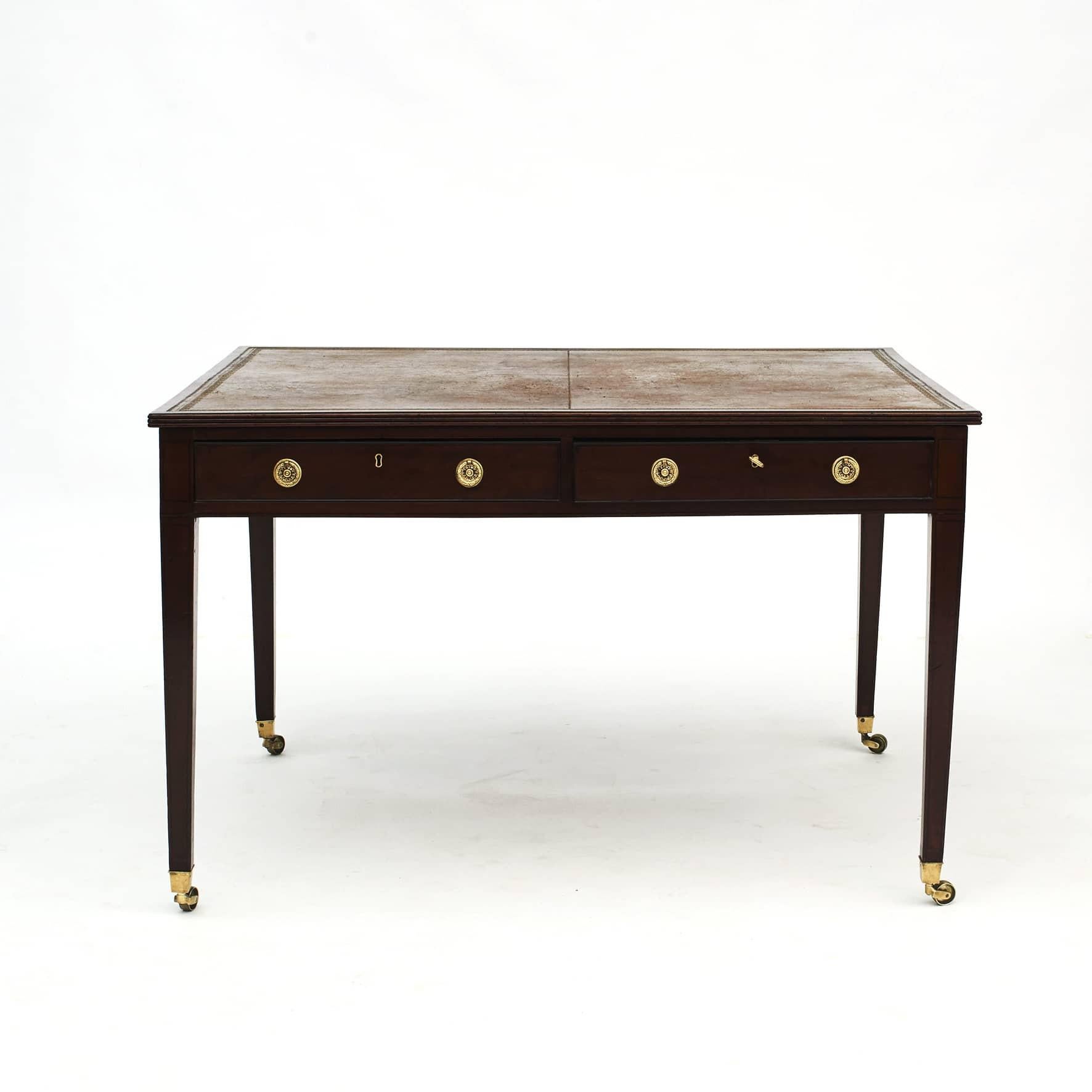 Early 19th century Regency mahogany Partner's desk.
The rectangular top features a moulded edge with an inset leather writing surface. 2x2 front drawers, the sides is finished with decorative faux drawers.
Raised on four legs with dark wood