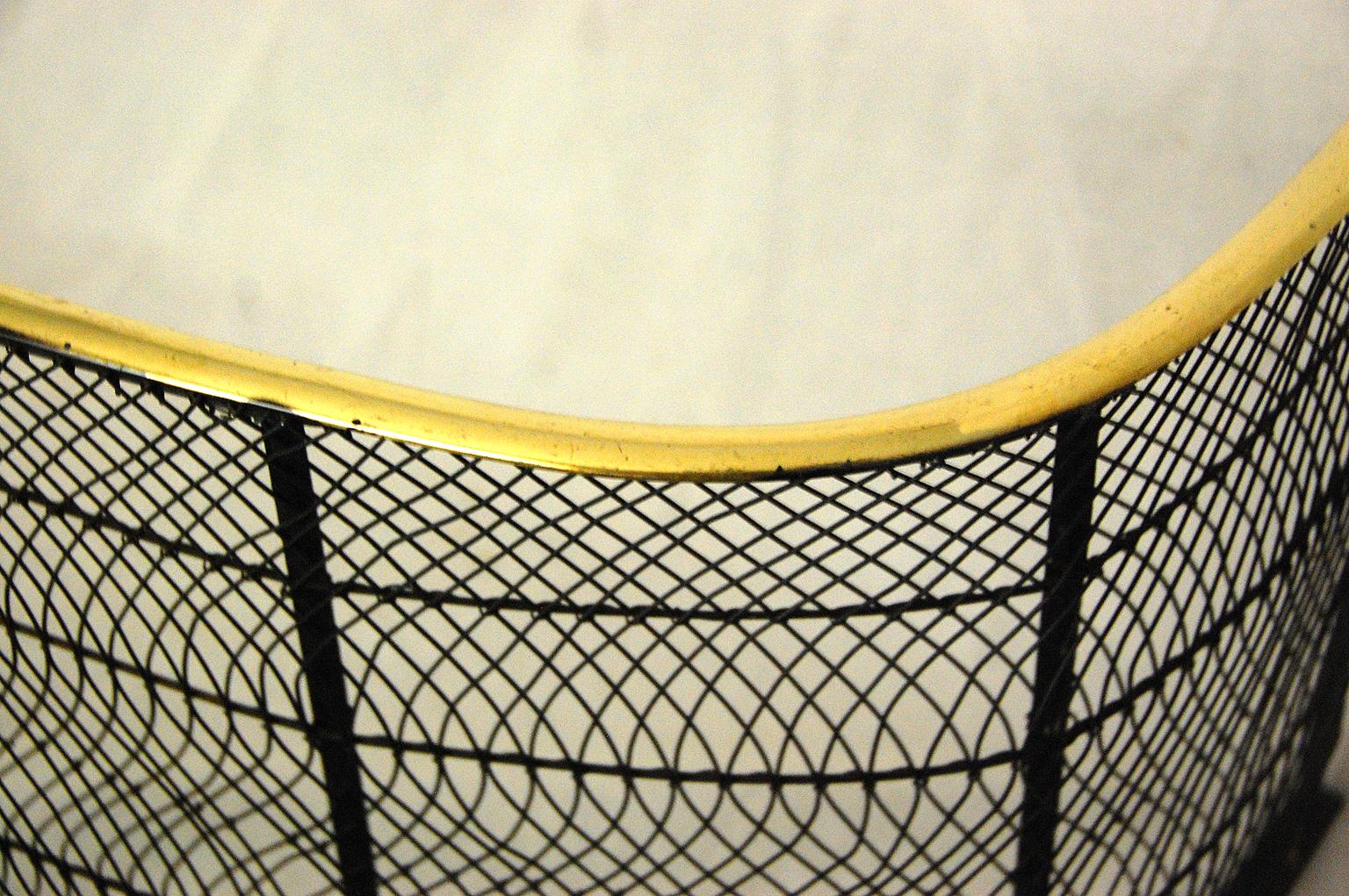 English Regency period brass and wire bowfront fender; 37 inches long, circa 1825.