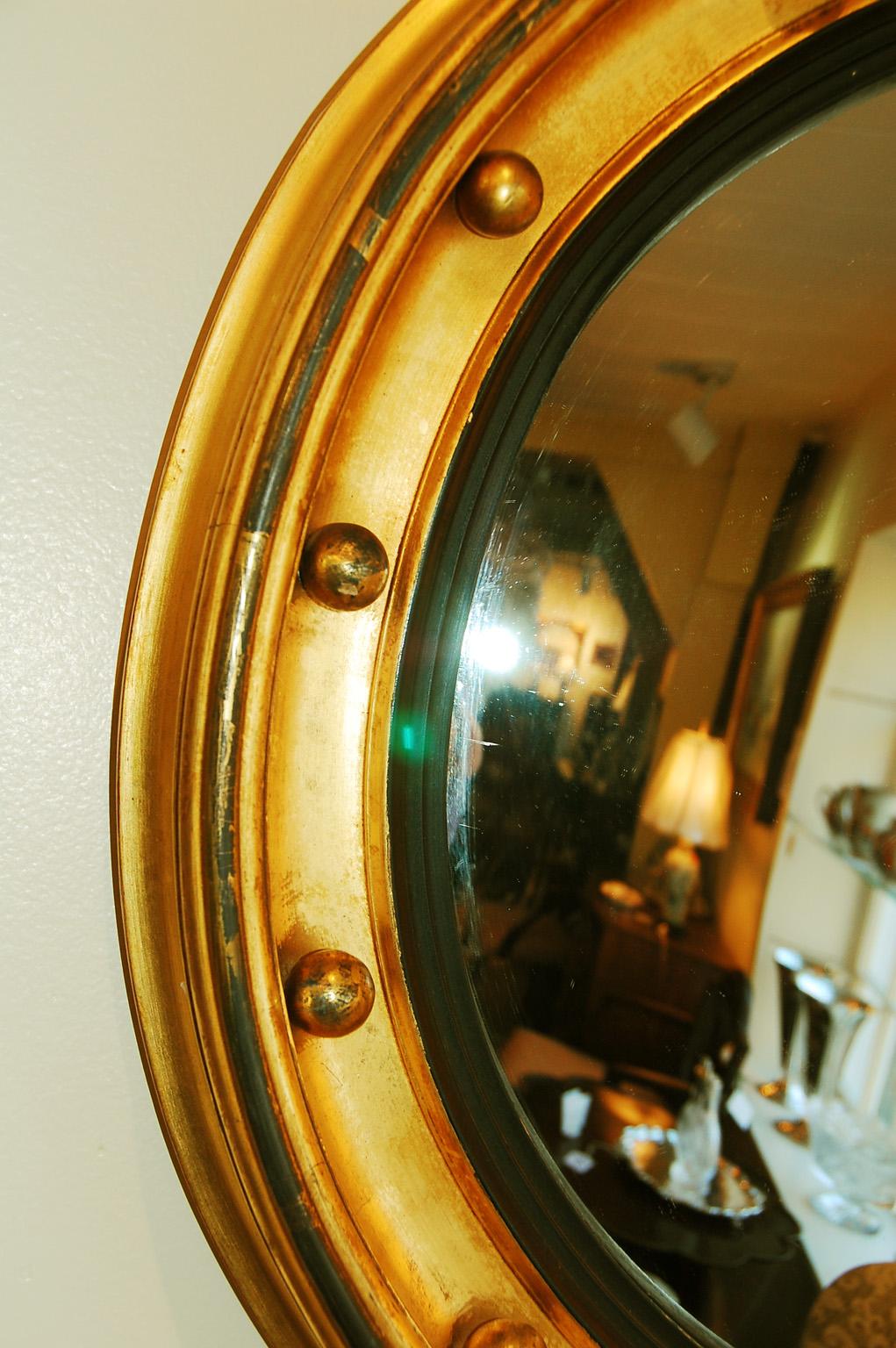 English Regency period gold leaf convex mirror with balls. This 20 1/2 inch diameter mirror is gold leaf on a wood carved base. It is possible that the convex mirror-glass itself is a late 19th century replacement, as it is not foggy like most early