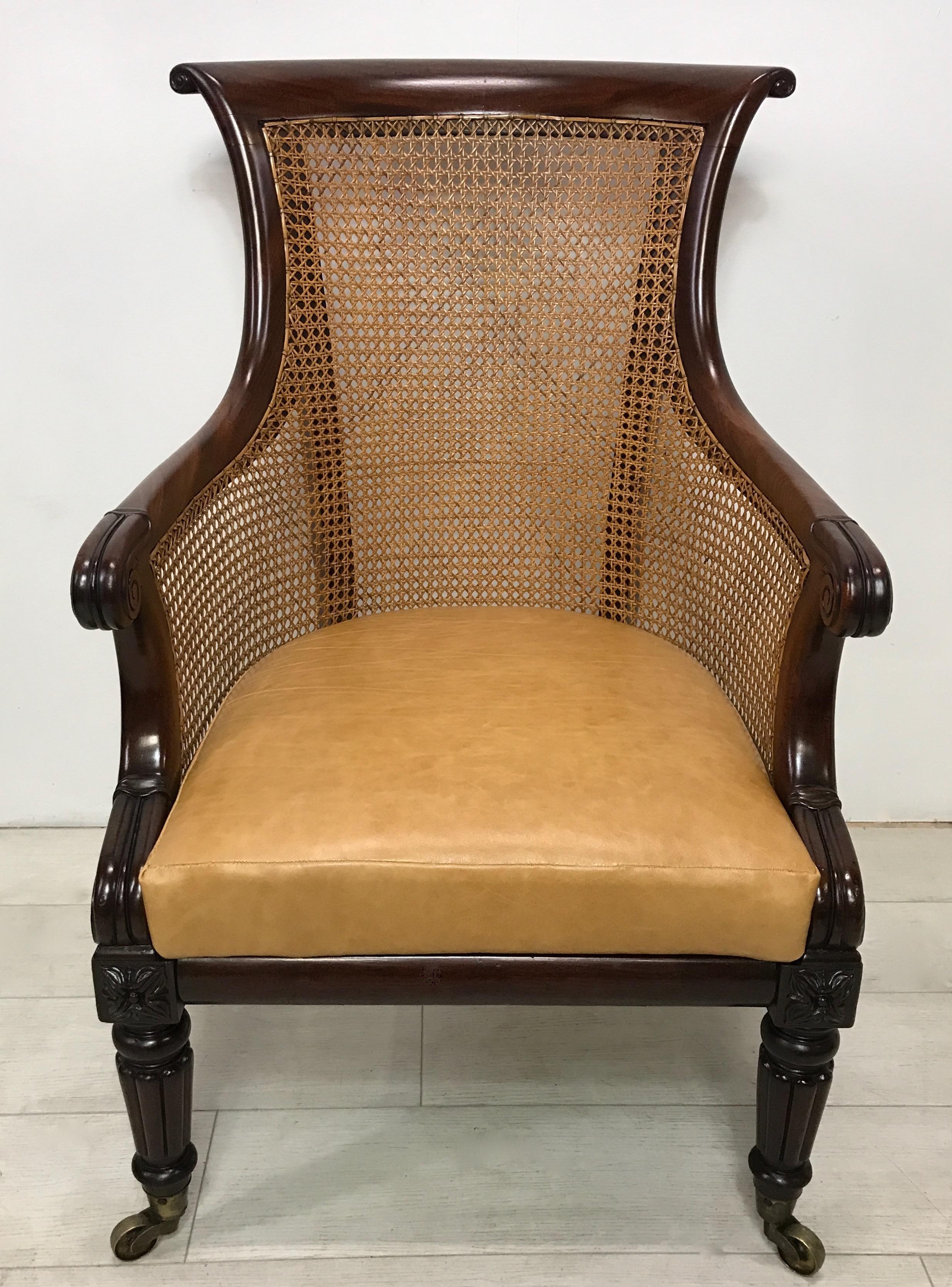 Regency period mahogany and caned filled library chair with removable leather cushion seat. This is a fine example of this style of chair.
In good solid condition, small professional repair to back leg, caning replaced in the second half of the 20th