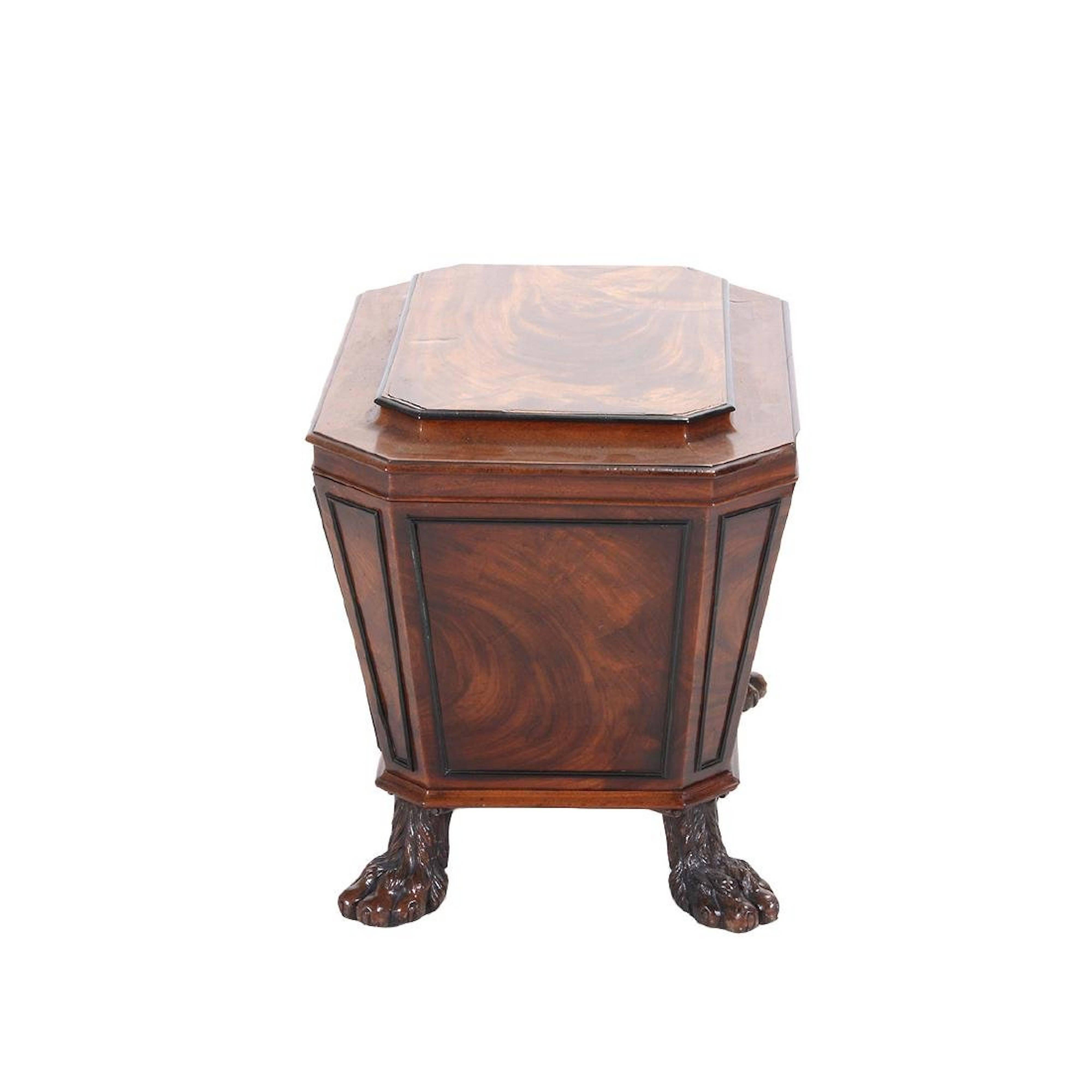 A fine and elegant circa 1810 English Regency period cellarette or wine cooler in the style of neoclassical designer Thomas Hope; the solid mahogany case of sarcophagus form having raised plinth form lid with canted corners above a conforming