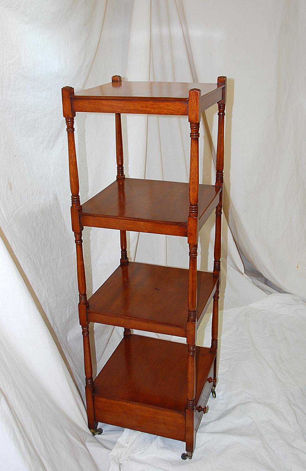 English Regency period mahogany four tier étagère with drawer, ring turned supports and drawer in the bottom make these display shelves quite versatile. They will handsomely display a collection or books and bibelots, adding height and style to an