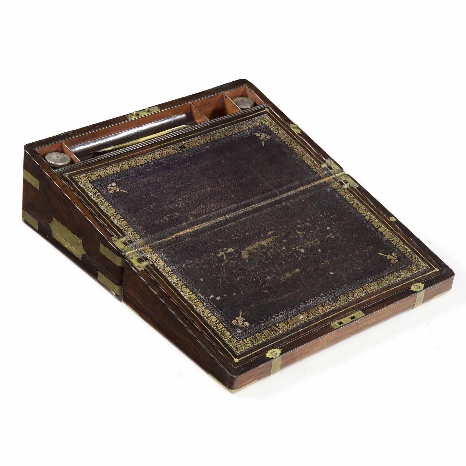 A RARE AND FINE REGENCY ROSEWOOD WRITING SLOPE
England, ca. 1815  Includes a quill by Isaac Parkes
Item # 801EZX27


An inordinately fine box, the exterior is dressed with full width and depth rosewood veneers carefully applied to flow between seams