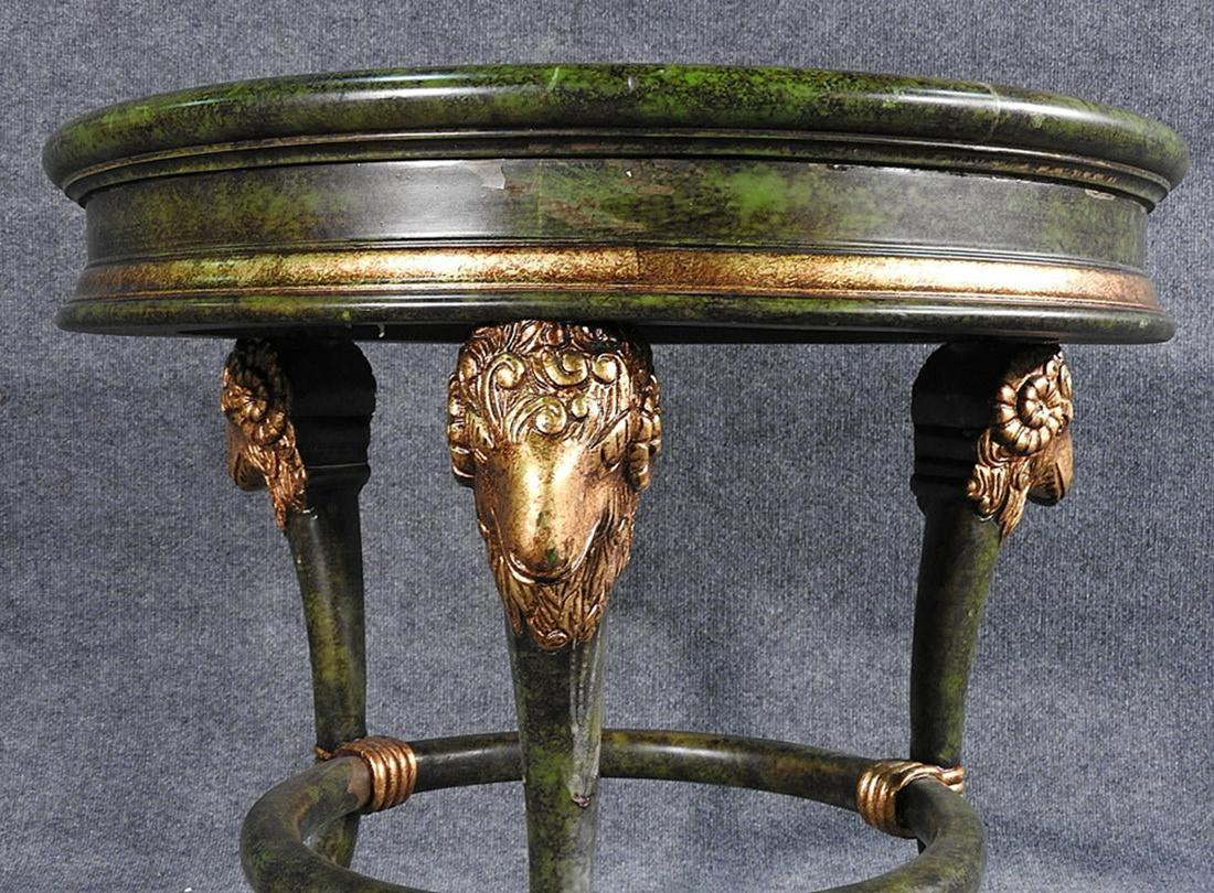 This is a beautiful end or occasional table that has been faux painted to look like green marble with gold leaf gilded rams heads. Measures 25 1/2