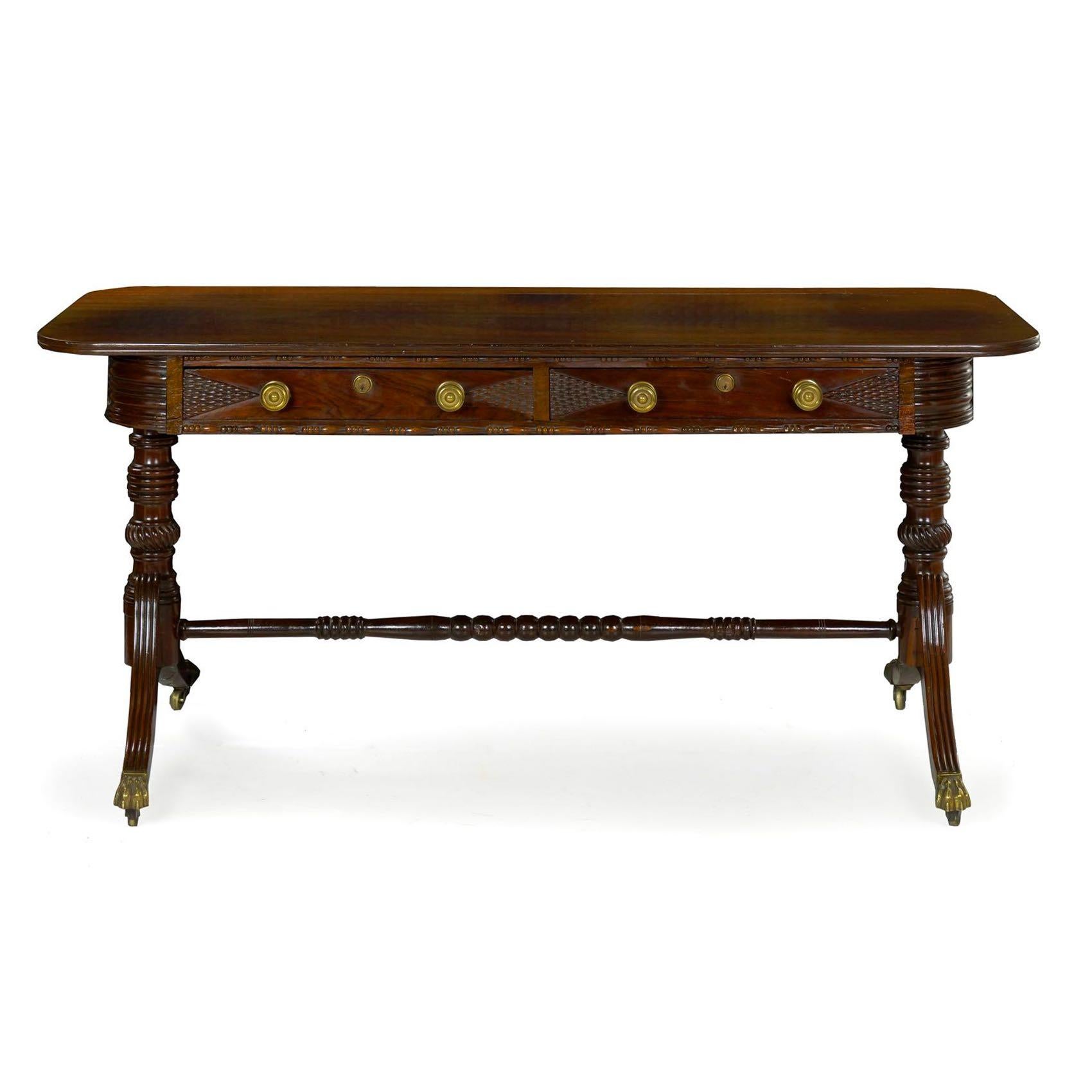 A handsome Anglo-Indian Regency writing table, it is executed with solid Brazilian rosewood planks, a wood now nearly extinct and rare in this vibrant and chaotic grain. The dense grain takes a French polish beautifully with a rich shellac surface