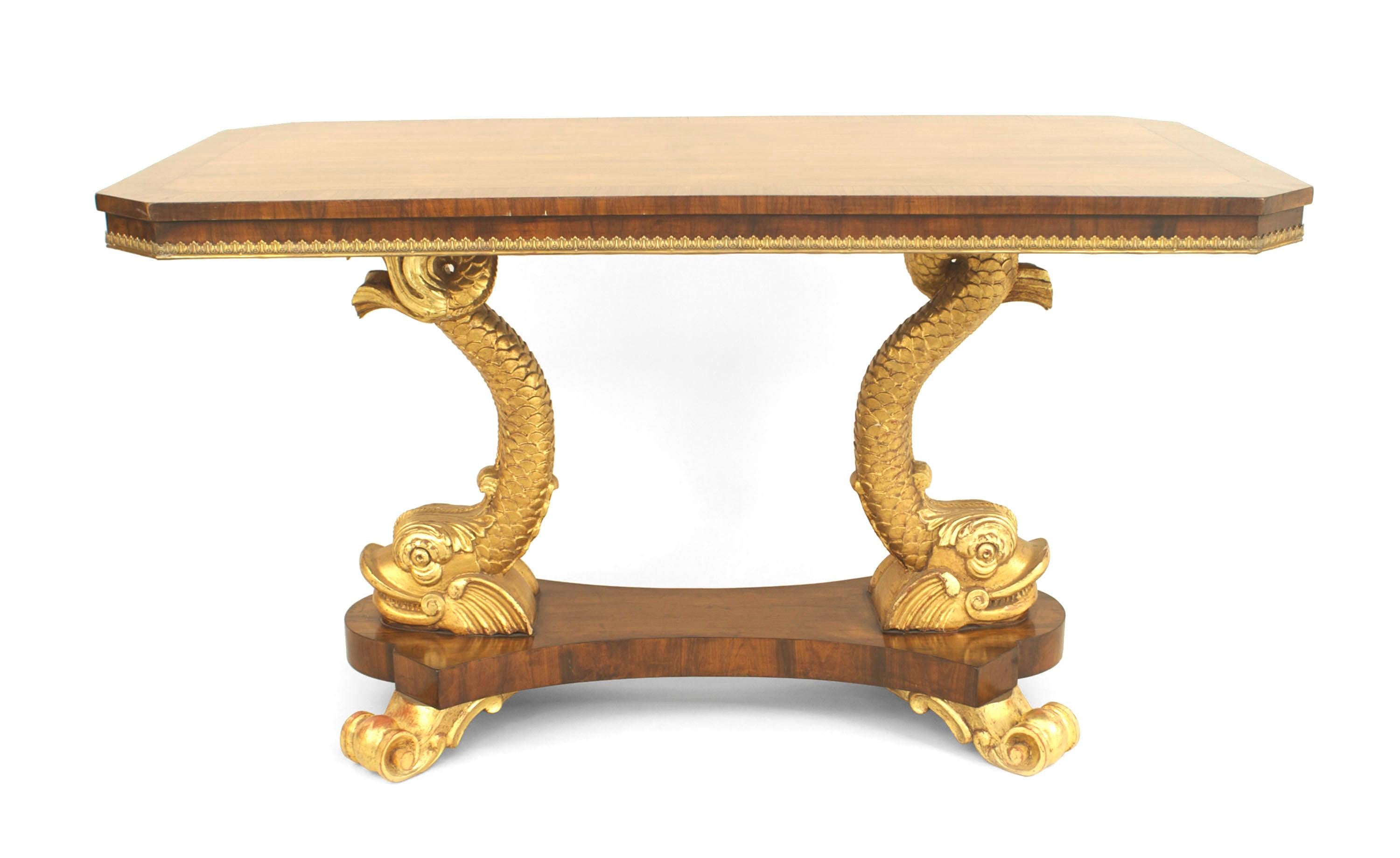 19th century English Regency style rosewood rectangular center table with brass trim on top and 2 carved gilt dolphins supported on platform base with gilt scroll feet.