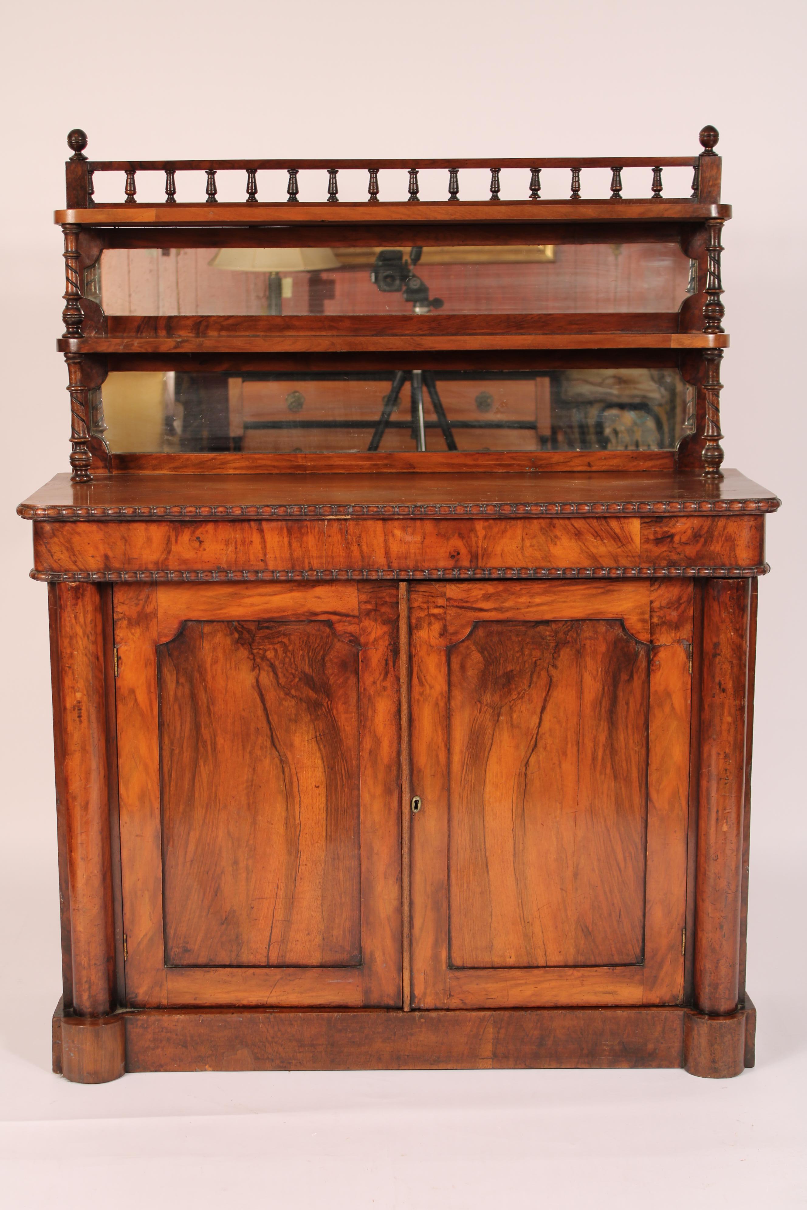 English Regency two part rose wood chiffonier, early 19th century. In two parts, the top part with a baluster turned gallery over two narrow shelves with a mirrored back, a 14