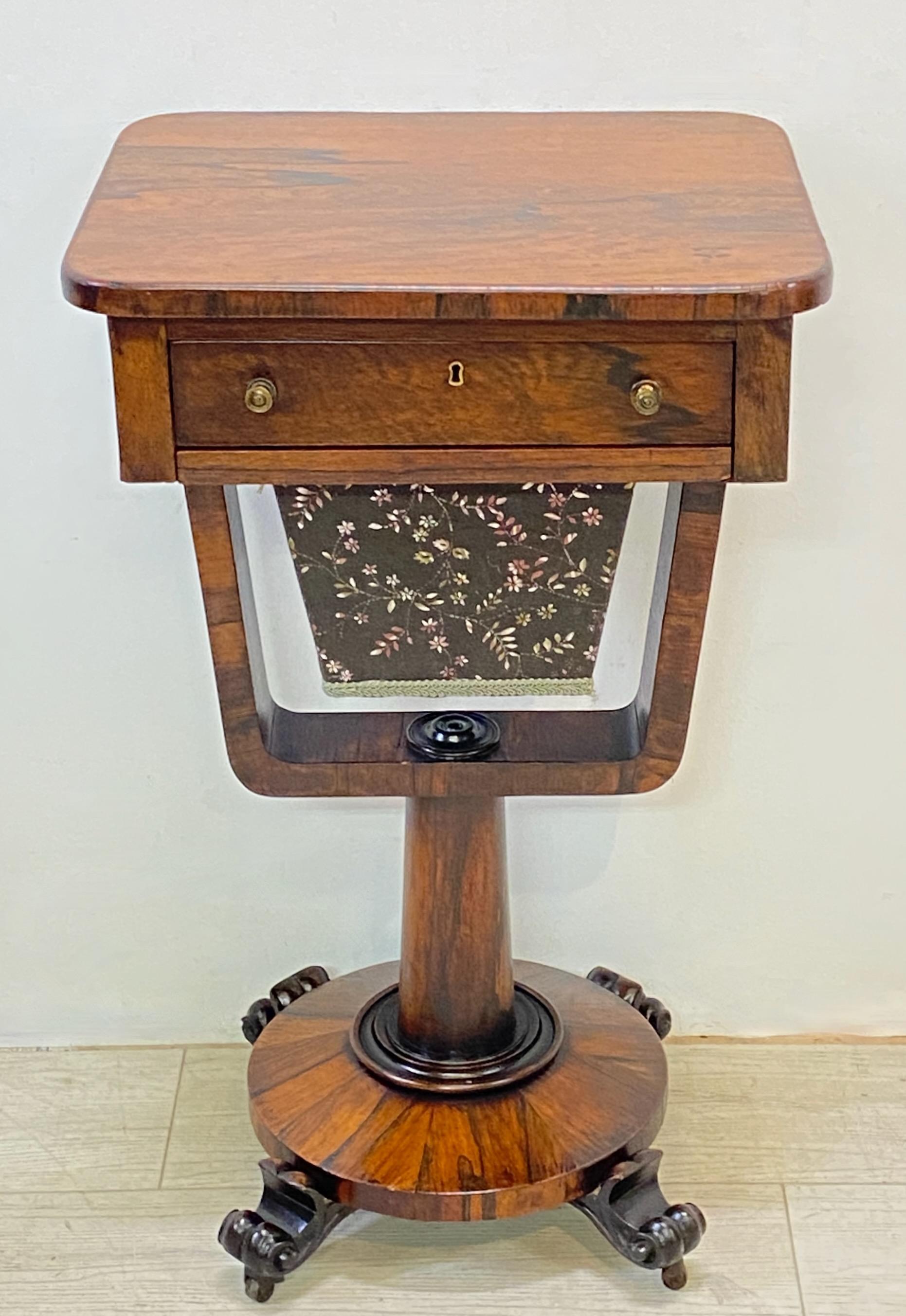 English Regency period rosewood sewing / knitting side table with a single drawer. Retains its original its basket liner, the outer basket fabric has been expertly replaced.
Refinished sometime in the last half of the 20th century.
In remarkable