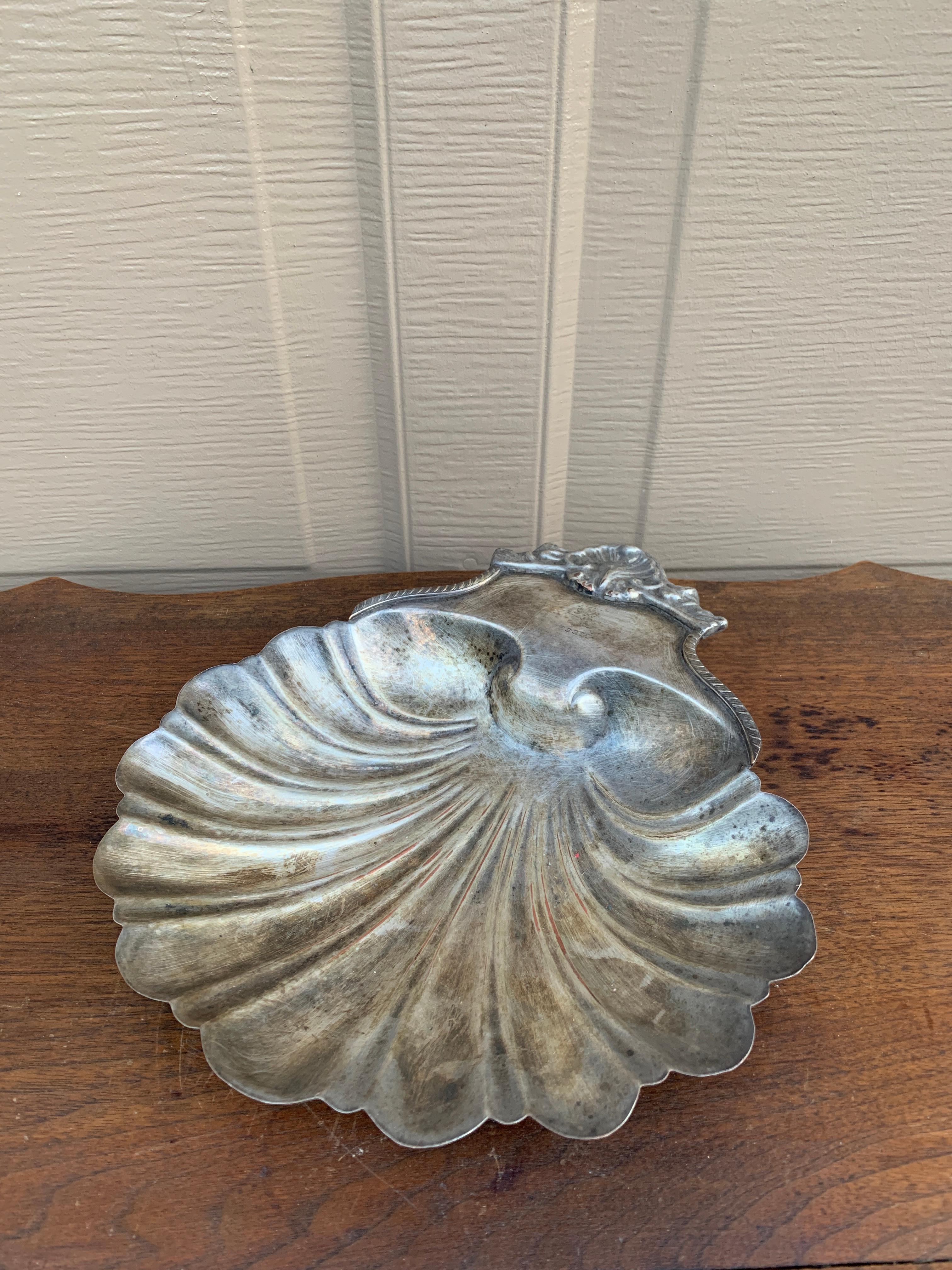 Magnifique plat de service en argent de la Régence anglaise en forme de coquille de palourde festonnée, reposant sur trois pieds en forme de coquille de conque.

Angleterre, 19e siècle

Mesures : 9,63 