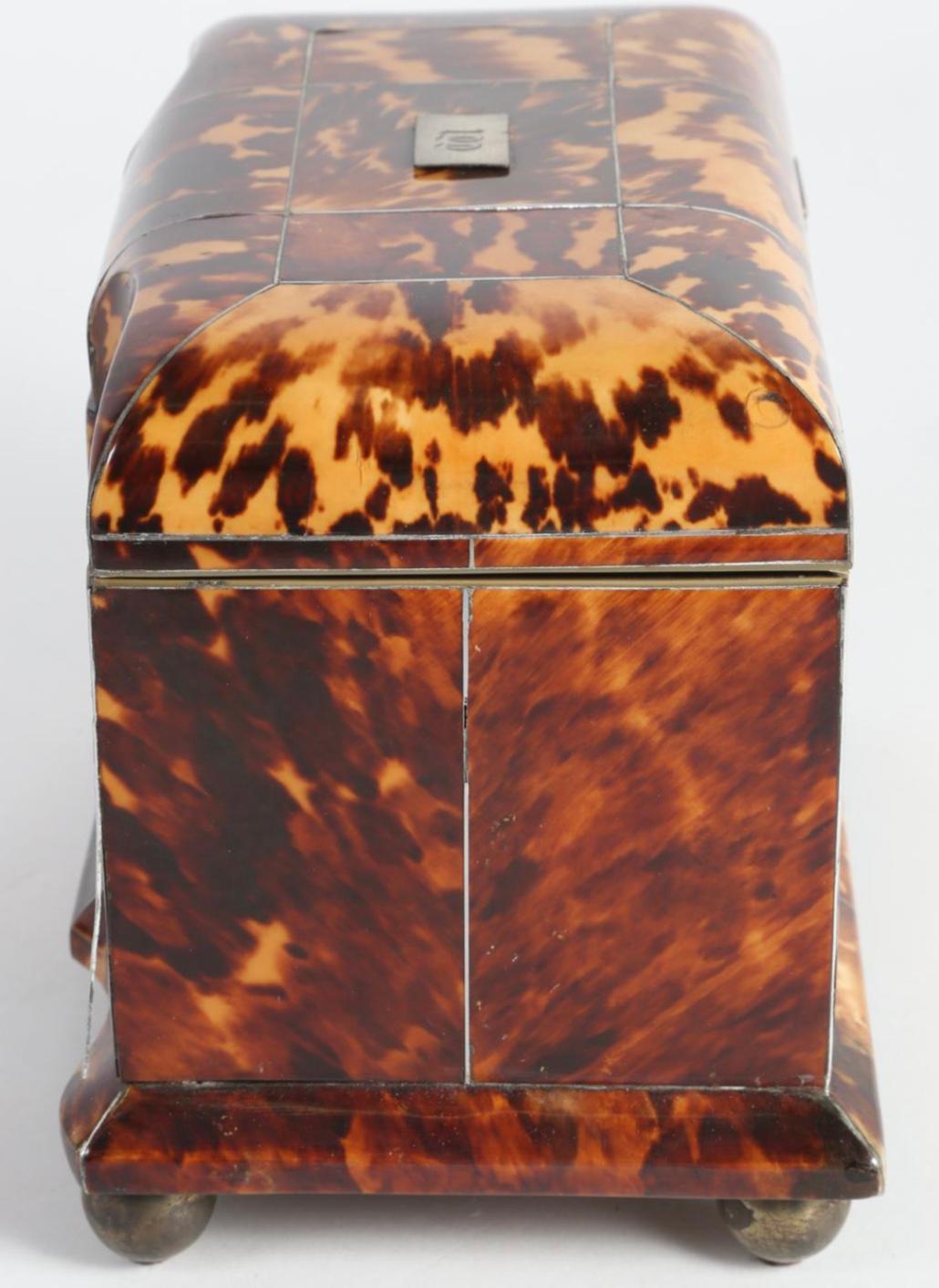 English Regency silver inlaid turtle shell double tea caddy, 19th century. English Regency block front or serpentine form tortoise shell tea caddy, the top with silver nameplate monogrammed, and line inlay, the base with line inlay and ball feet,