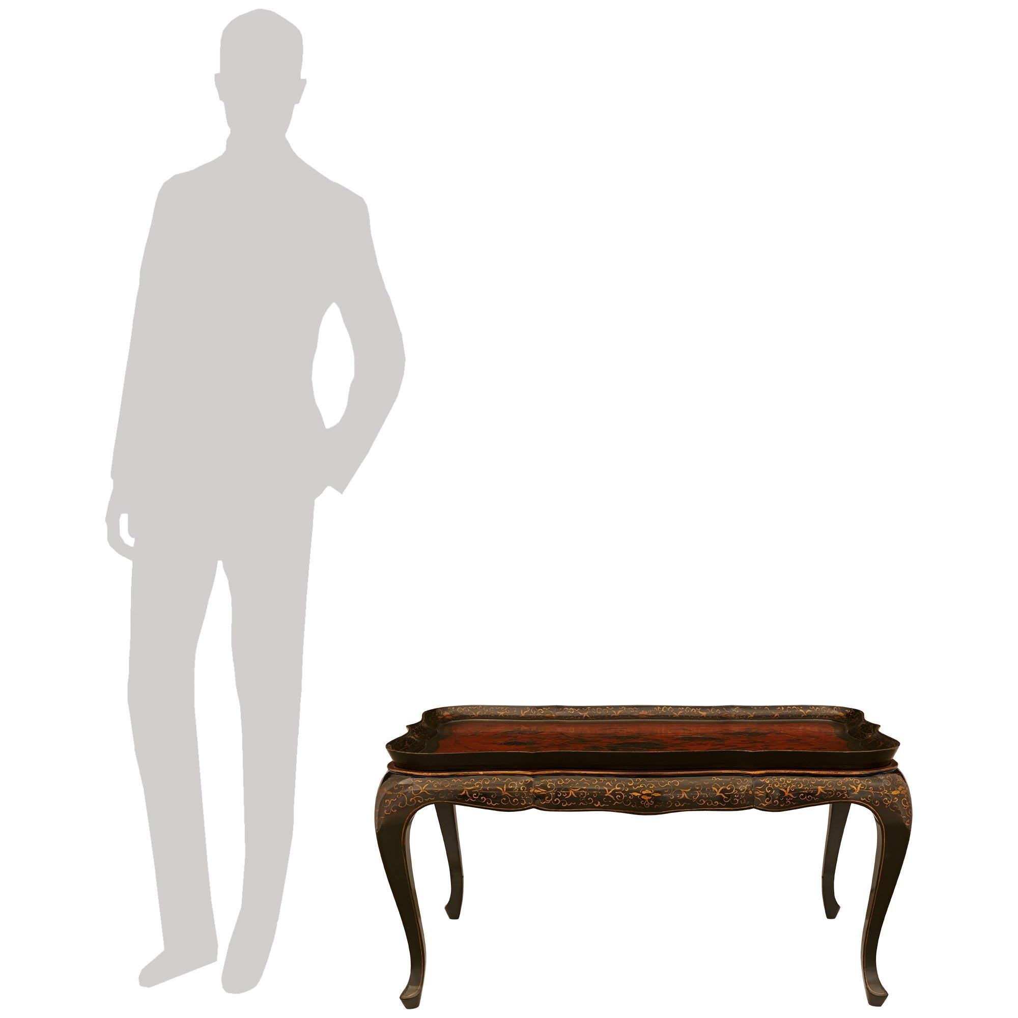 A beautiful English 19th century Regency st. Lacquer and Gilt coffee table with removable tray. This Chinoiserie coffee table is raised by most elegant cabriole legs with a delicate Gilt fillets leading up each leg and along the scalloped frieze.