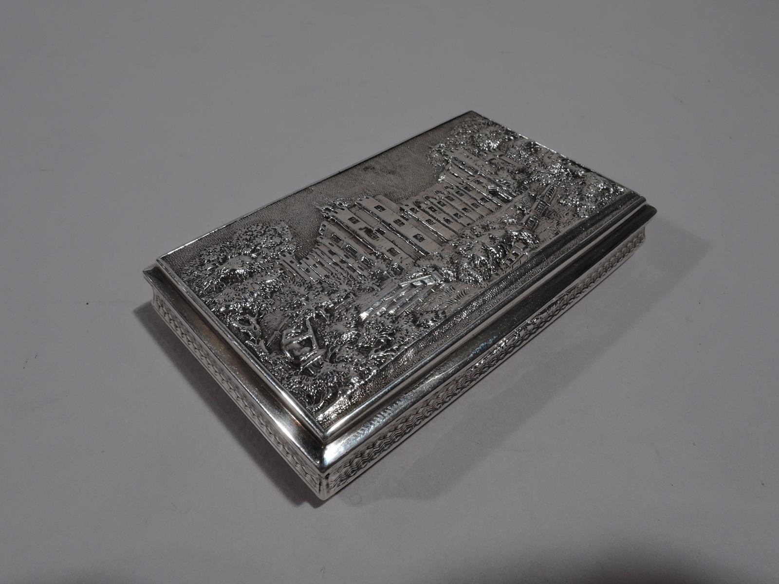 William IV sterling silver snuffbox. Made by Nathaniel Mills in Birmingham in 1836. Rectangular with concave sides and hinged cover. On cover is Elizabethan manor in bosky grounds; with castellated turrets and enough glazed and mullioned apertures