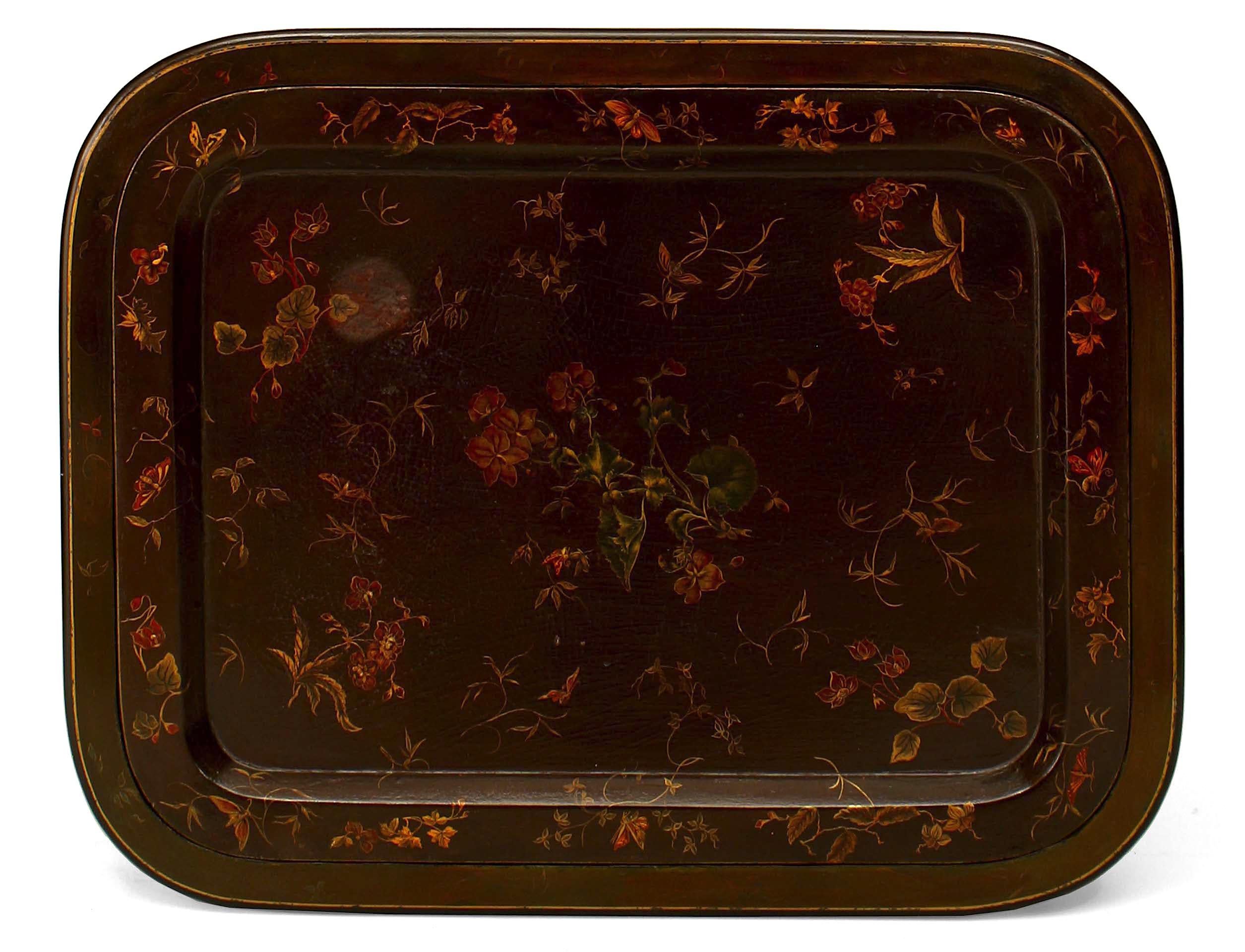 English Regency style (19/20th Century) brown lacquered tray top coffee table with decorative floral design and a black lacquered and gilt double faux bamboo leg base.
