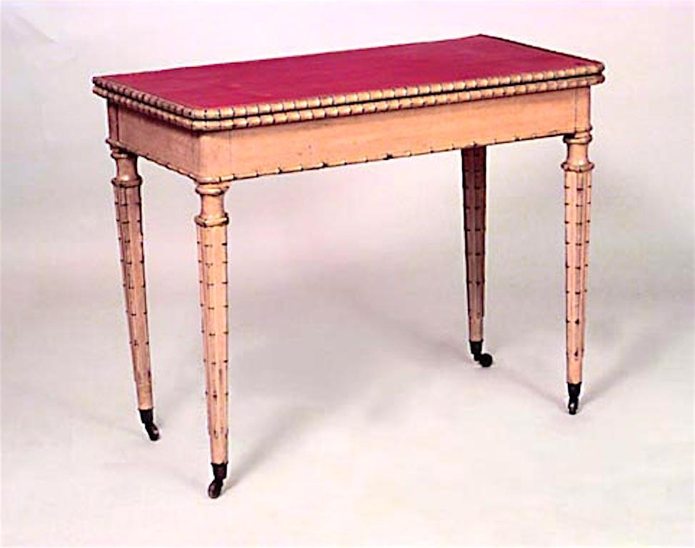 English Regency style (19th century) painted faux bamboo four legged flip-top console table with red leather top.
 