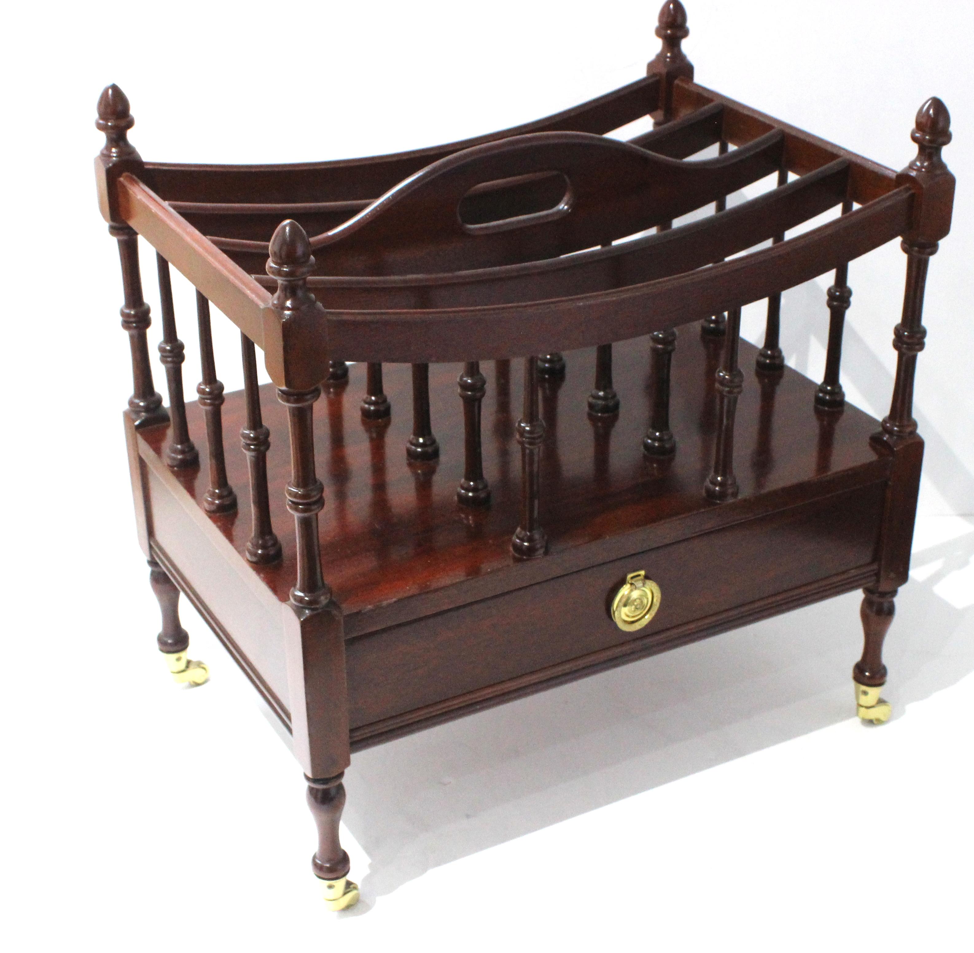 This stylish English Regency style cantebury is fabricated in mahogany with brass hardware.
