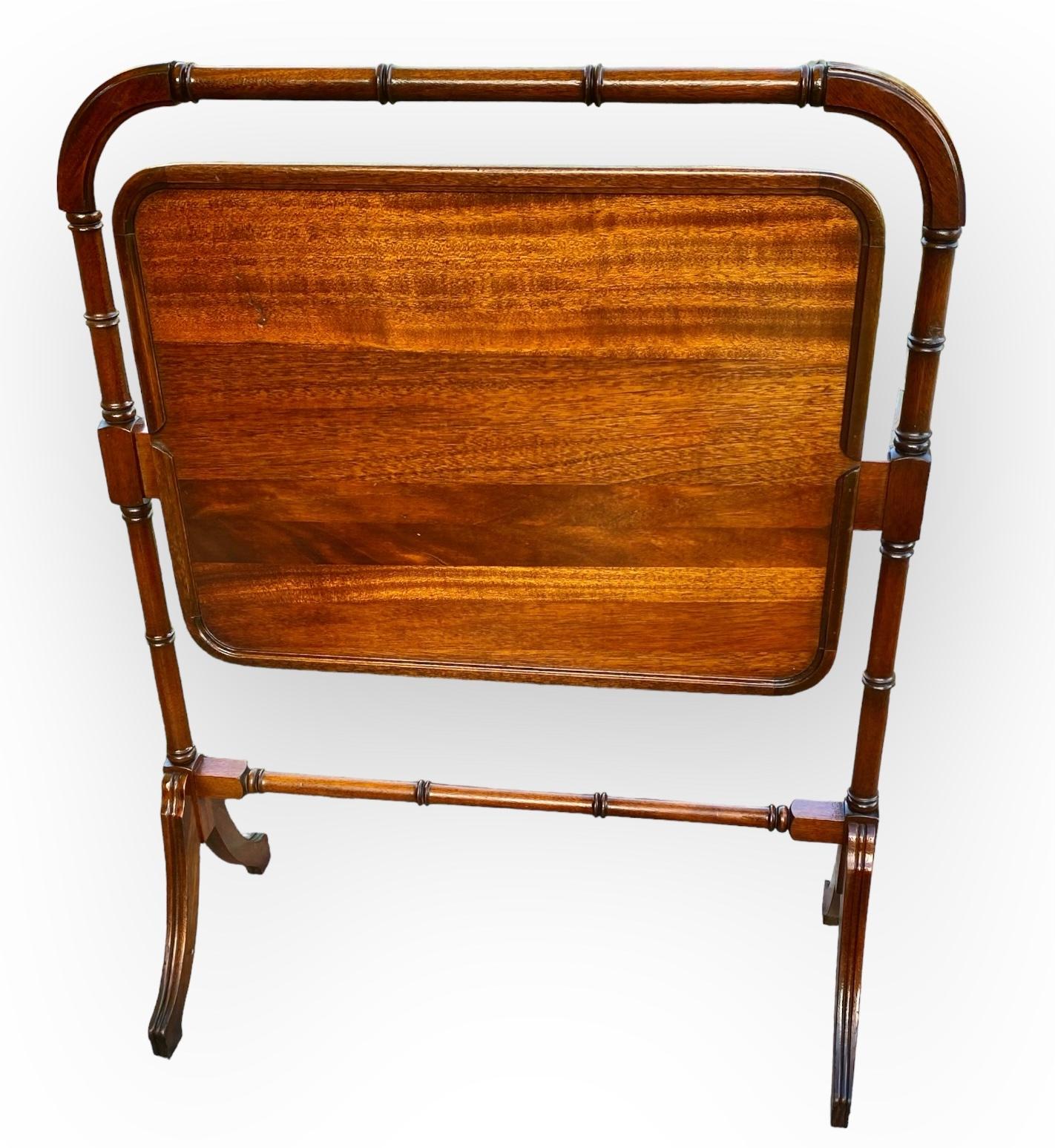 A rare and unusual English Regency style mahogany folding flip-top table with wooden gallery, early 20th century, having a carved bamboo turned frame, encasing folding table top, on graceful splayed legs.
It was originally used for tea time but