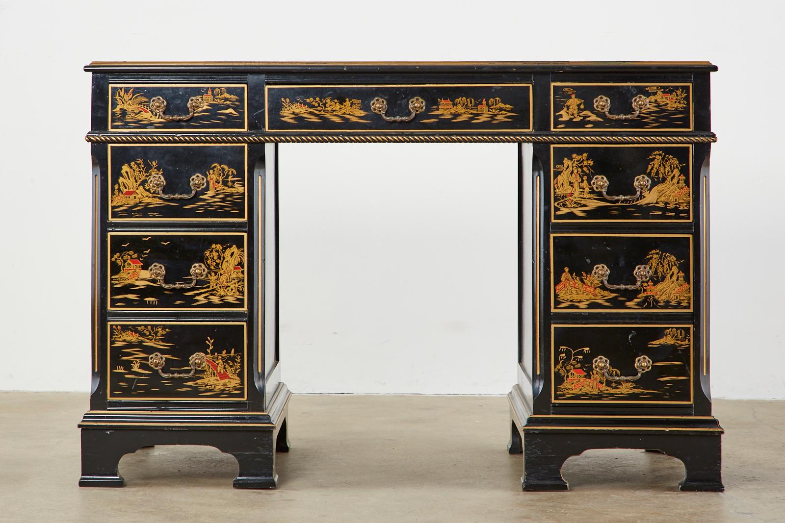 Distinctive English Regency style knee hole desk or writing table featuring a Japanned case decorated with chinoiserie painted scenes. The desk has a pedestal design with a leather top writing surface. The case has a decorative rope trim around the