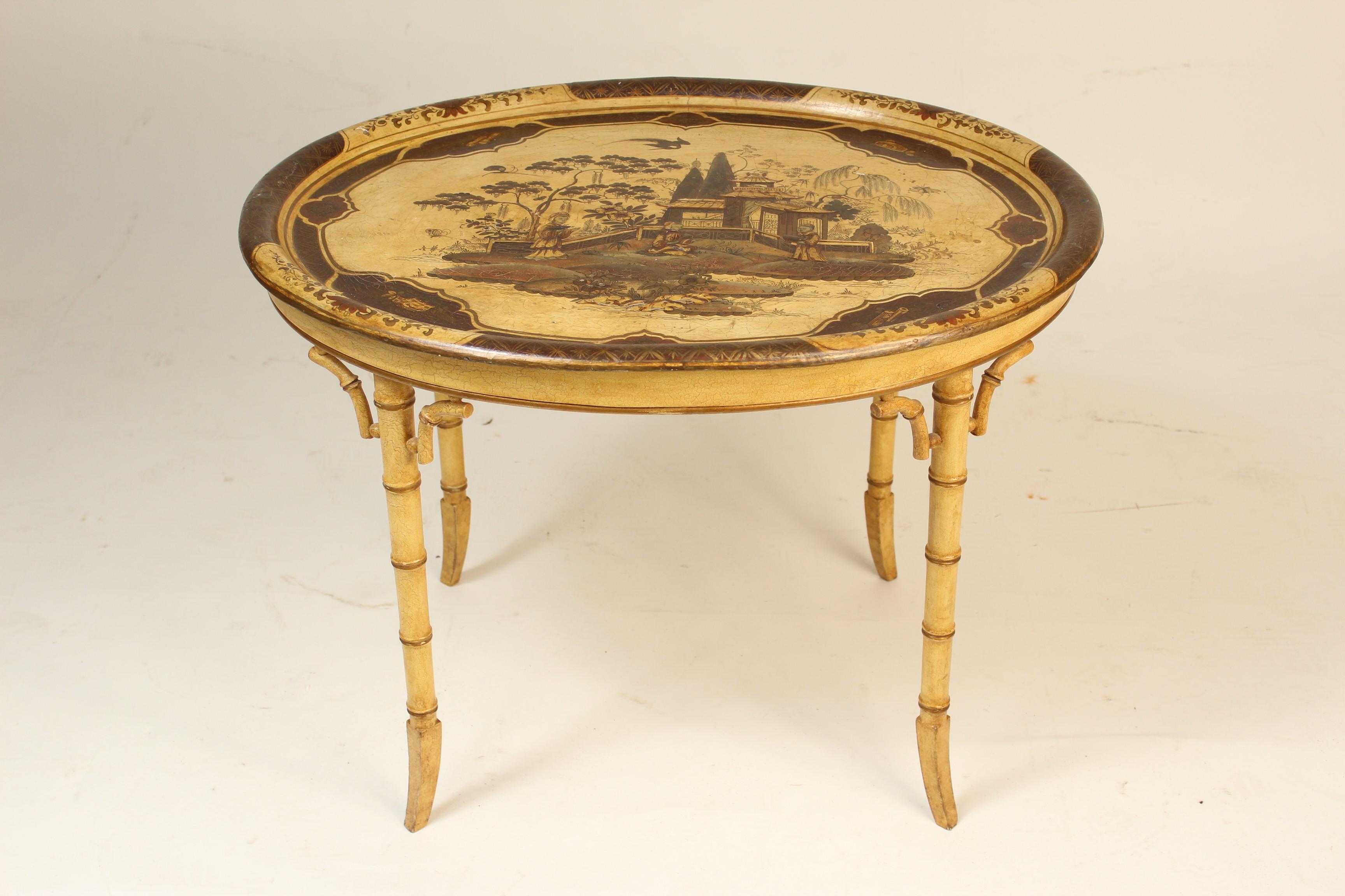 English Regency style cream colored chinoiserie decorated papier mâché tray, late 19th century, on a 20th century bamboo style turned base. The chinoiserie decorated tray has raised decorations and a crackled finish.
