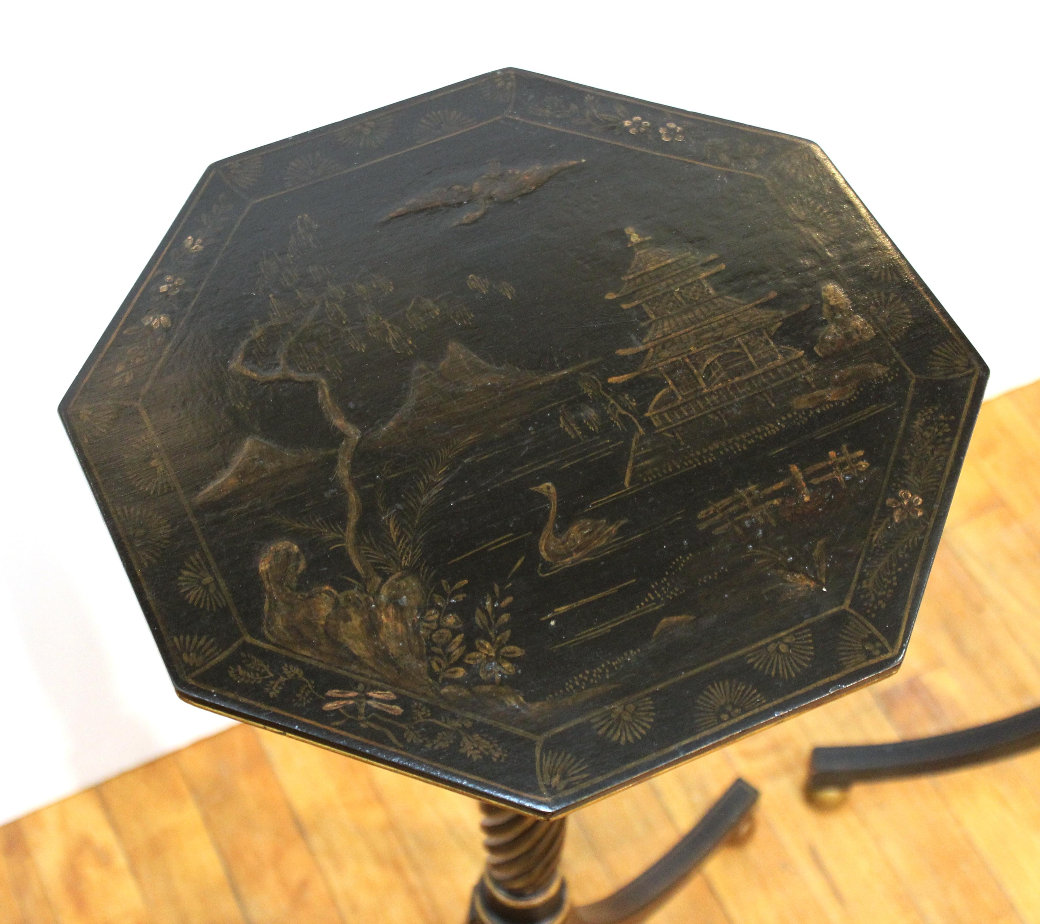 Pair of English Regency style chinoiserie lacquered side or end tables with tilt tops, on twisted fluted columns and tripod legs.
