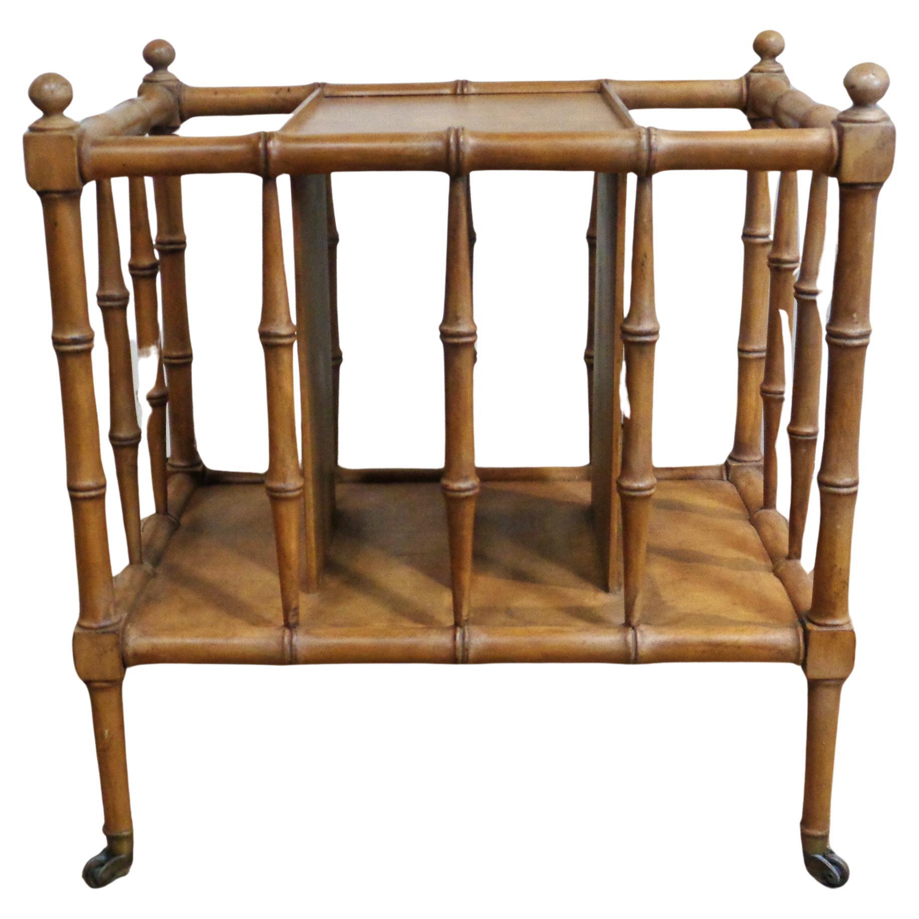English Regency style faux bamboo burlwood and walnut canterbury magazine rack with original brass cup rolling wheel casters. Overall nicely aged warm surface color to wood and brass. Attributed to Baker Furniture Company, Circa 1960's . Look at all