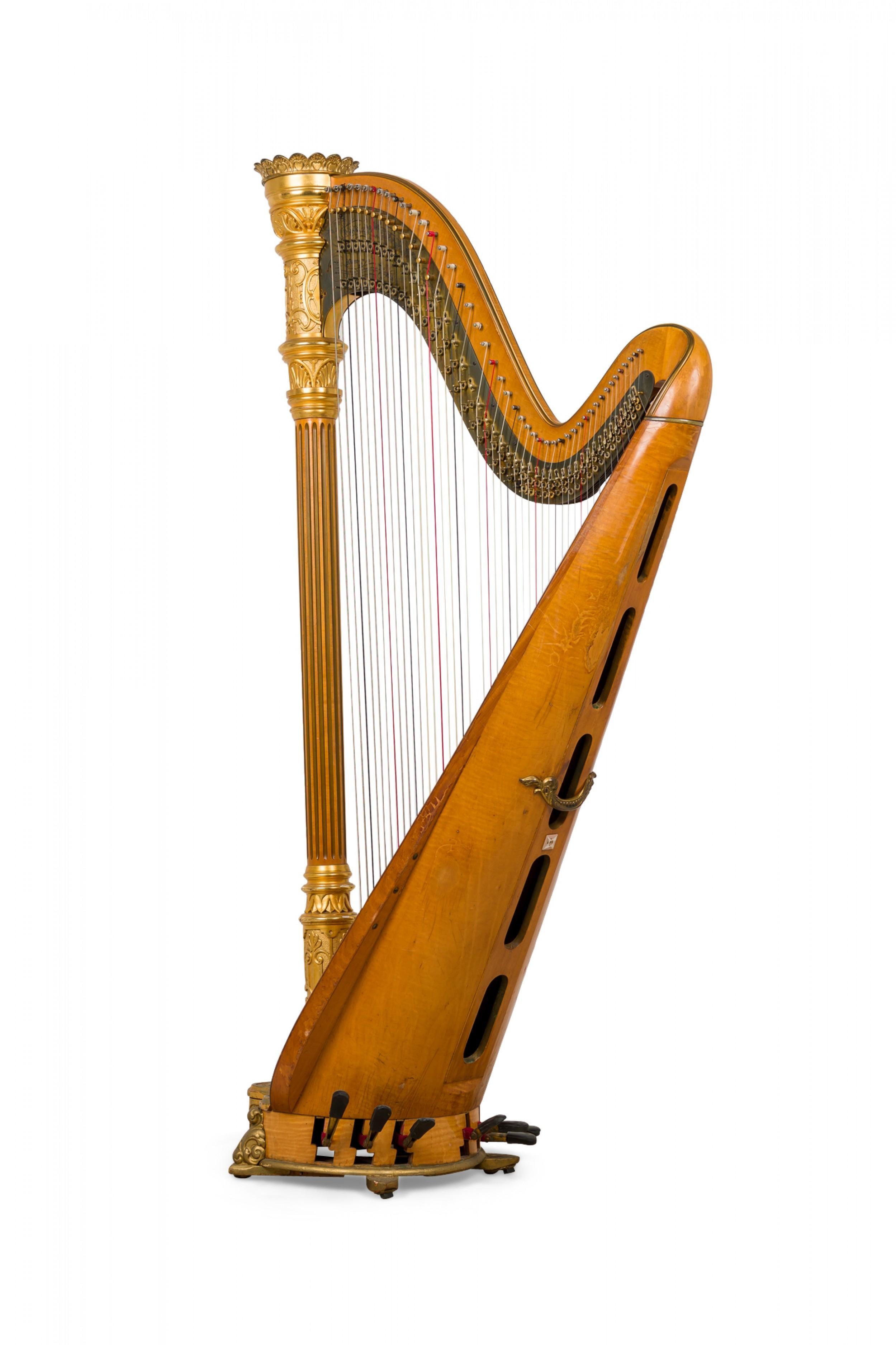 Harpe de style Régence anglaise en bois satiné et garniture dorée, quarante-six cordes en laiton, double action, 7 pédales, support colonne cannelé surmonté d'un fleuron couronne, sur un motif symétrique de rinceaux et de feuillages (LYON &
