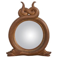 Miroir serpentin en bois doré sculpté de style Régence anglaise avec dauphins