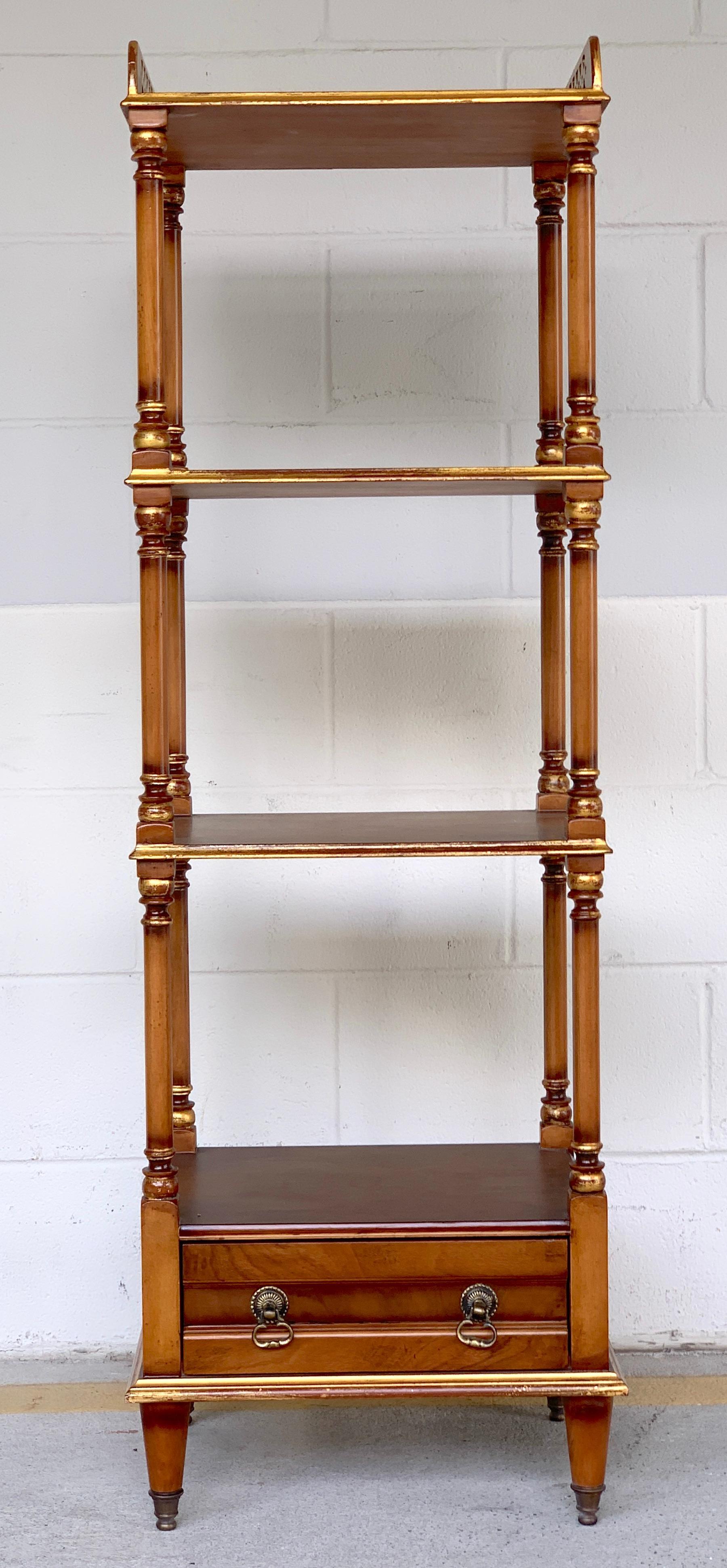 English Regency style mahogany and burl three tier étagère, with pierced 2-Inch high giltwood gallery, and one bottom drawer, with gilt highlights, raised on brass sabot legs.
Three 13.5” depth x 15” width x 12” height shelves
One 13” x 4”