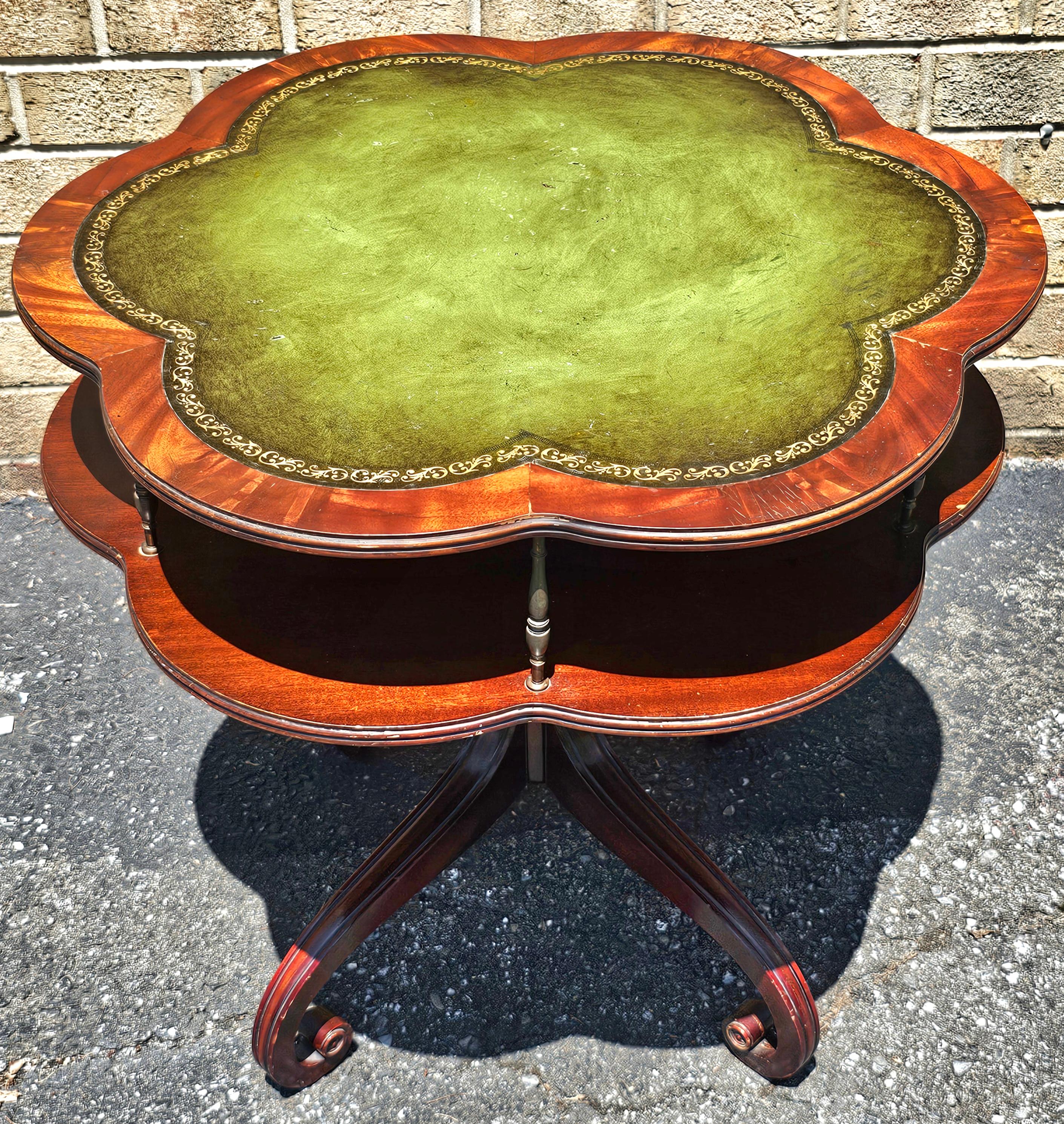 An English Regency Style Mahogany and Green Tooled Leather Inset Top with gold Stenciled Two Tier Center Table or side table with scallop edges.
Measures 30