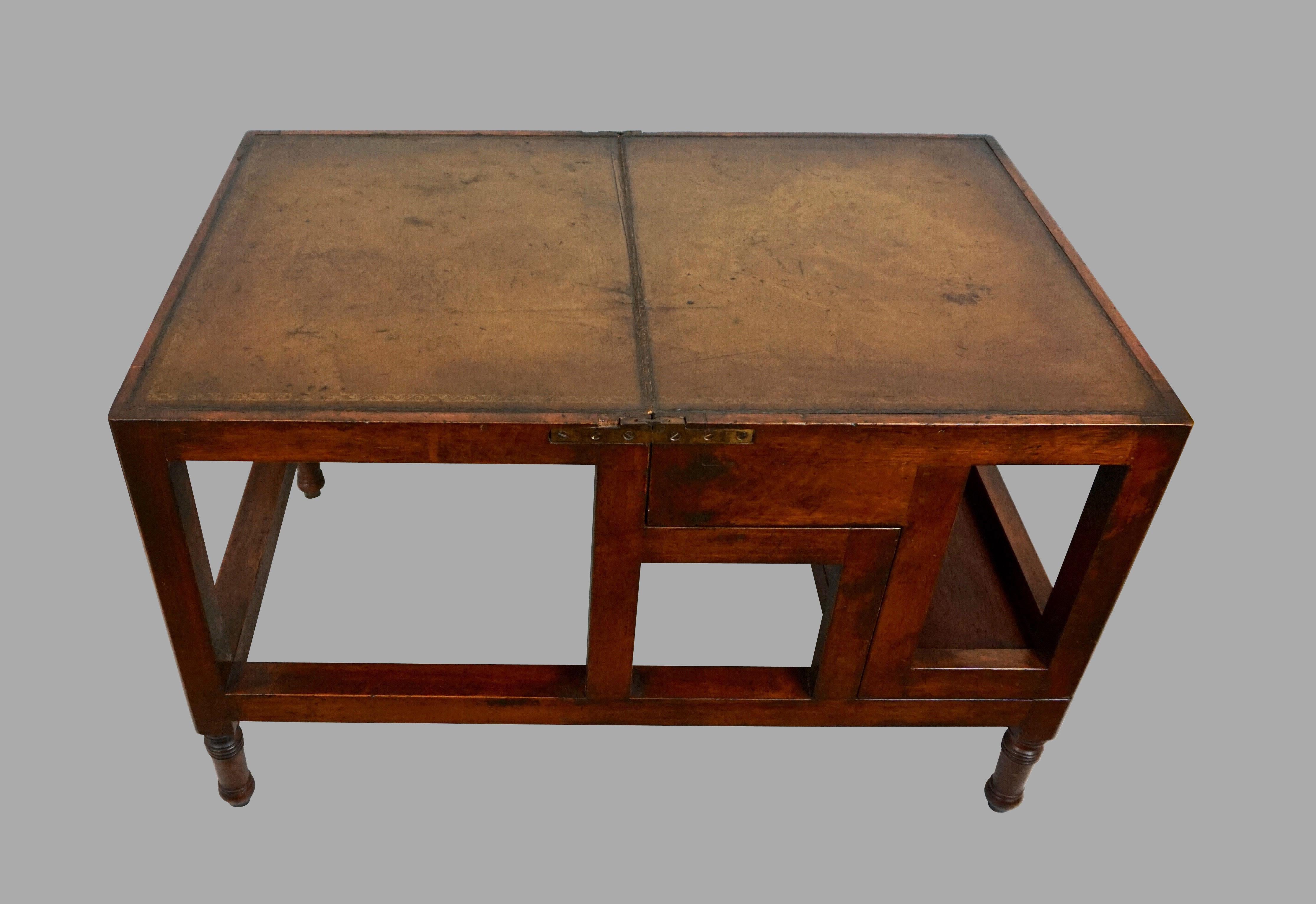 An English mahogany Regency style metamorphic library table with a brown tooled leather top which when opened becomes a library stairs with 4 tooled leather steps. This type of metamorphic furniture is very practical and decorative at the same time.