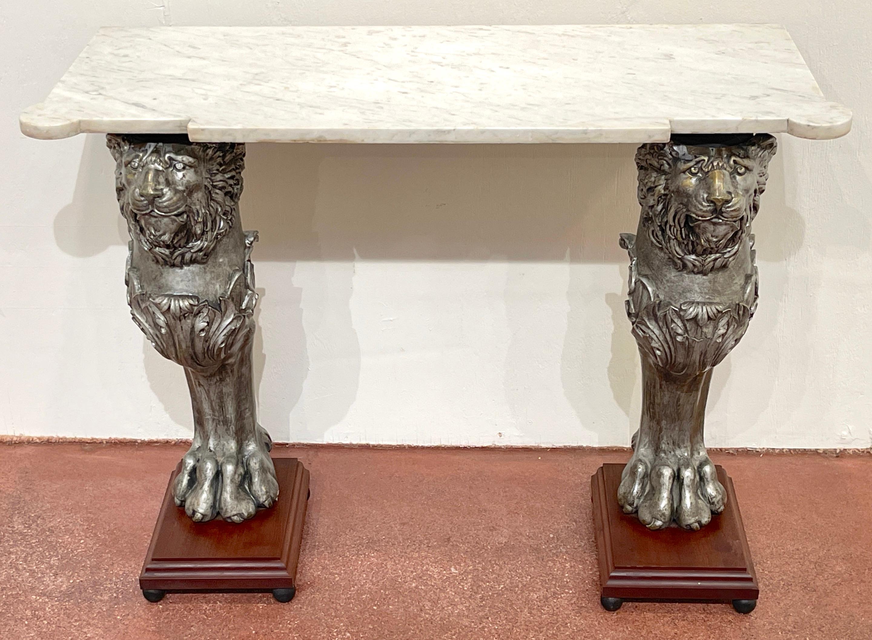 English Regency Style Marble Top Zinc Lion Caryatid Console Table 
England, circa 1900s

With canted cornered white marble top, raised on a pair of finely cast staunch silvered metal/zinc lion caryatids, resting on square mahogany pedestal bases