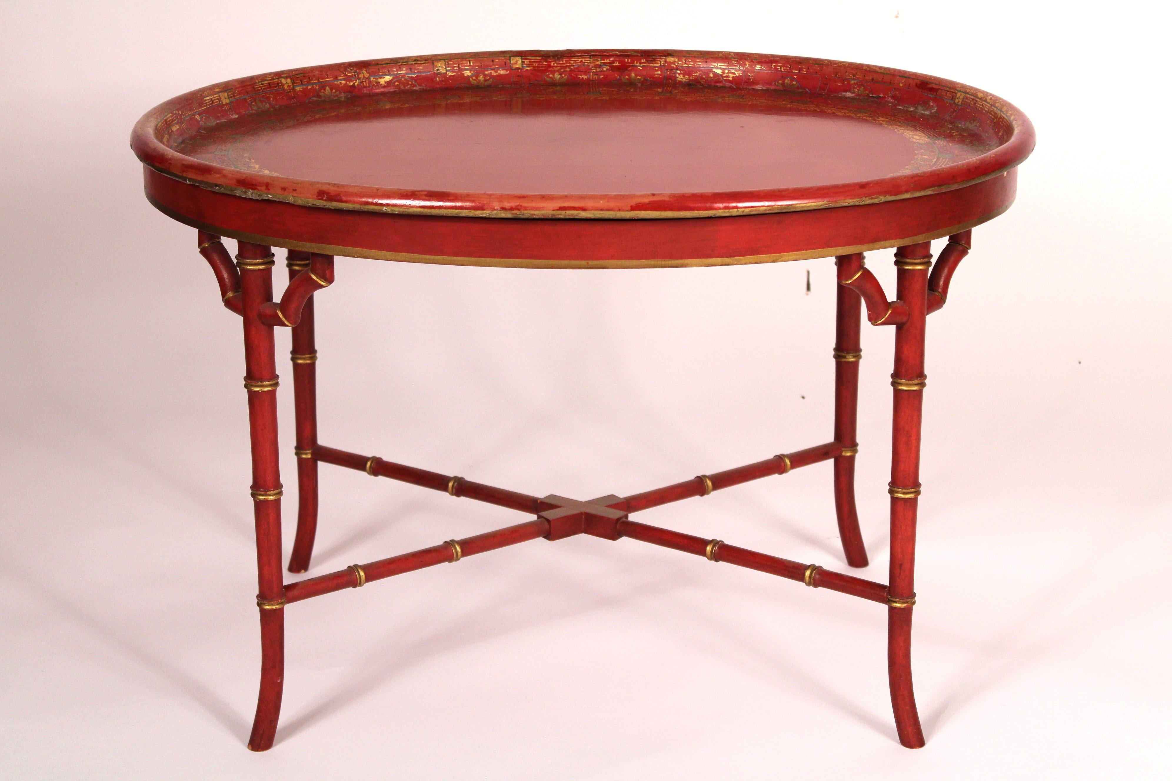 English oval paper mache, red lacquer and gilt decorated tray, late 19th century, on a red lacquer and gilt decorated bamboo style turned stand, circa late 20th century. With a Hedley's Humpers English shipping label on the back of the tray.