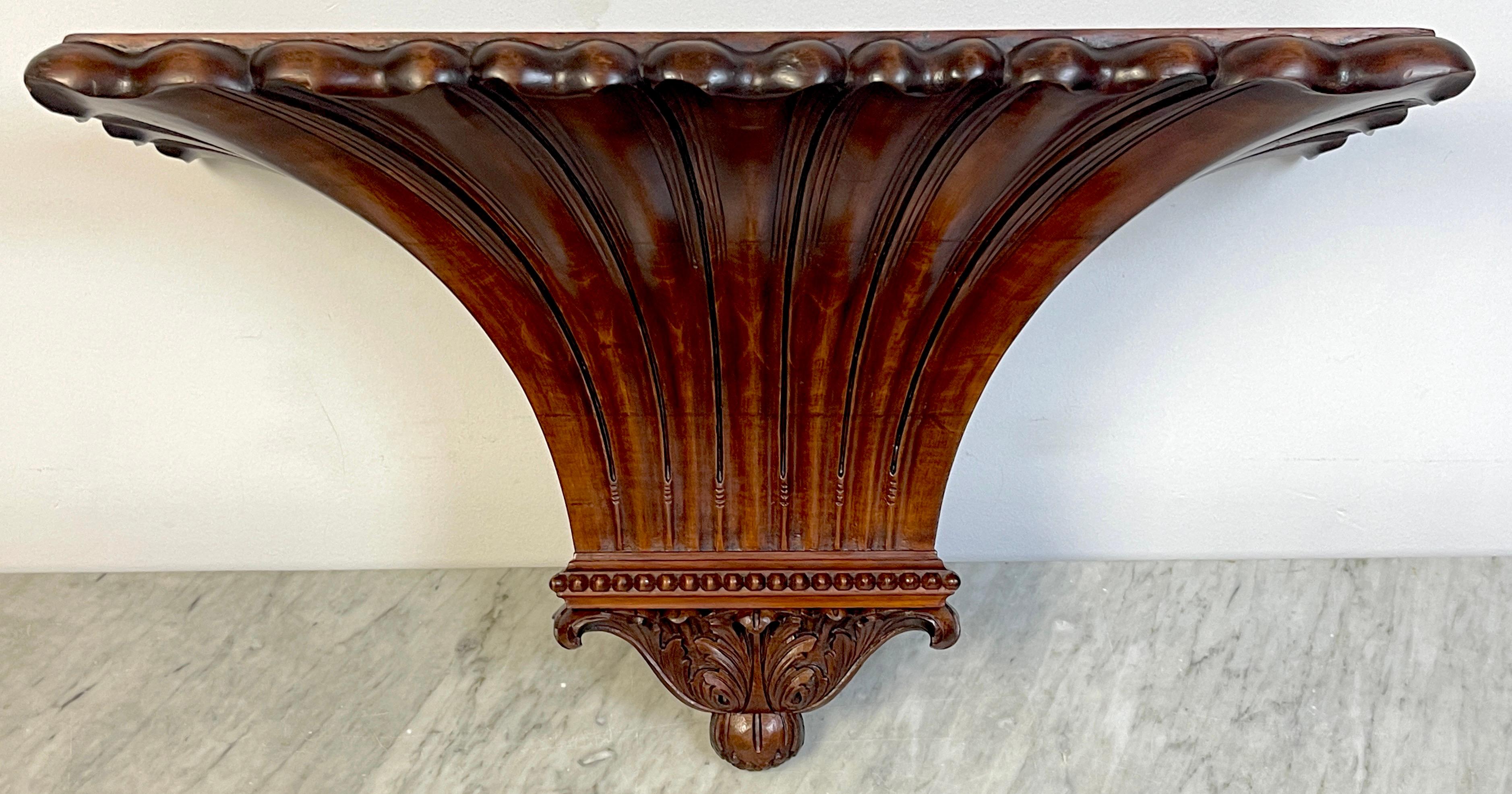 English Regency style plum pudding hardwood wall bracket/ shelf.
England, Circa 1900s.

A single substantial carved plum pudding hardwood wall bracket/shelf, large enough to hold a clock or sculpture. The flat top display shelf measures 26-Inches