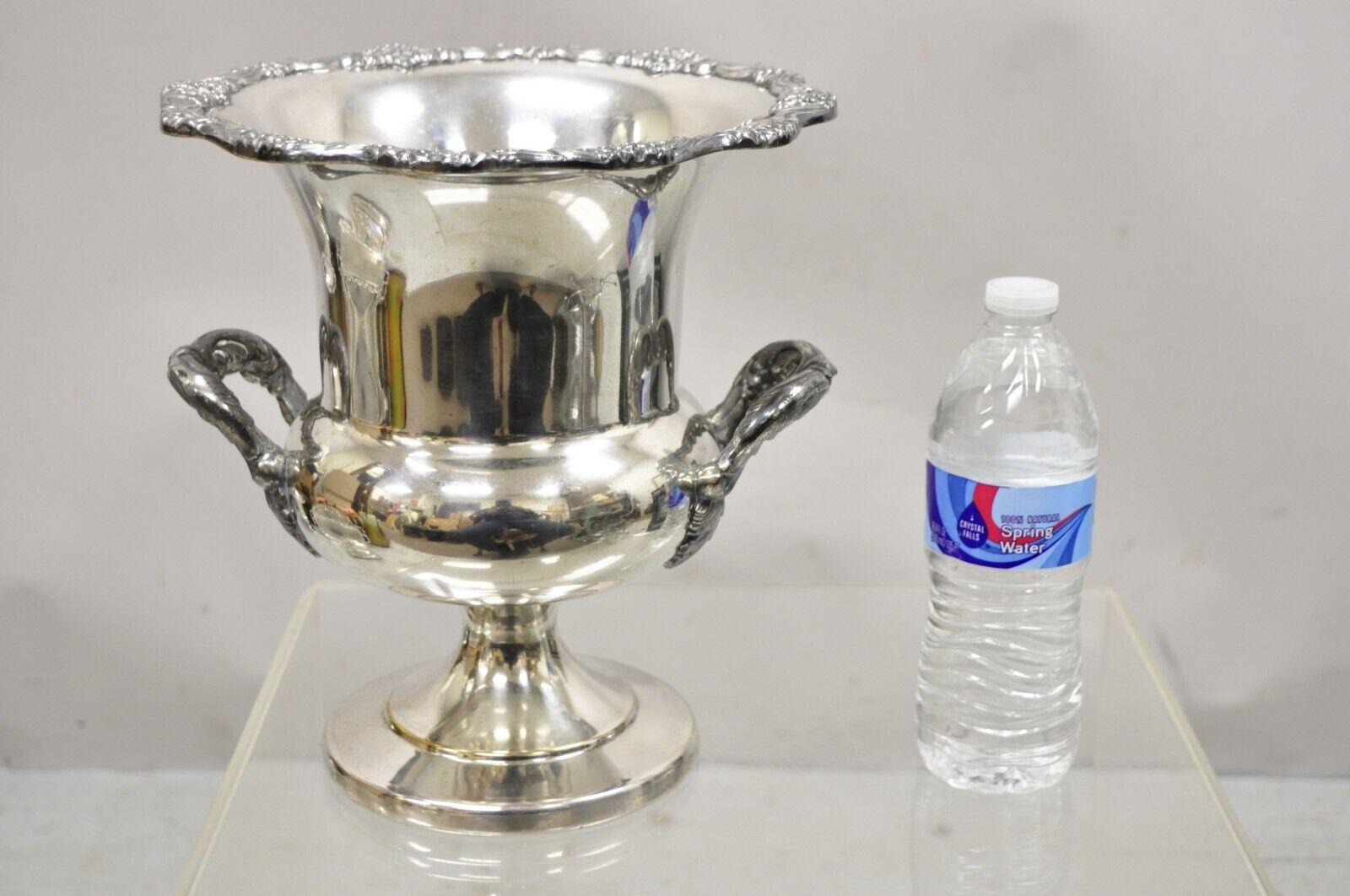 English Regency style silver plate trophy cup urn champagne wine chiller. Item features fancy twin handles, decorated rim, raised on a stepped base, very nice vintage item. Circa Early to Mid 20th Century. Measurements: 10.5