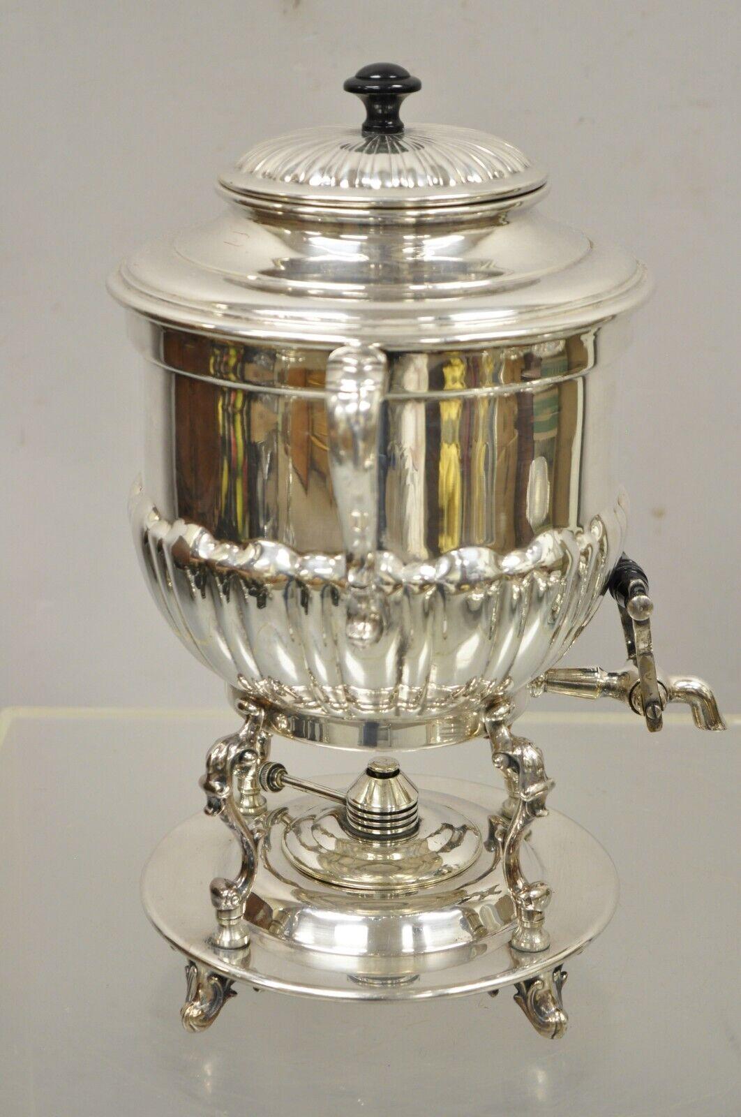 Vintage English Regency style silver plated Urn coffee dispenser samovar pot and burner. Item features lion and crown marking to base, removable burner, twin handles, very nice vintage item, quality craftsmanship, great style and form.
Circa early